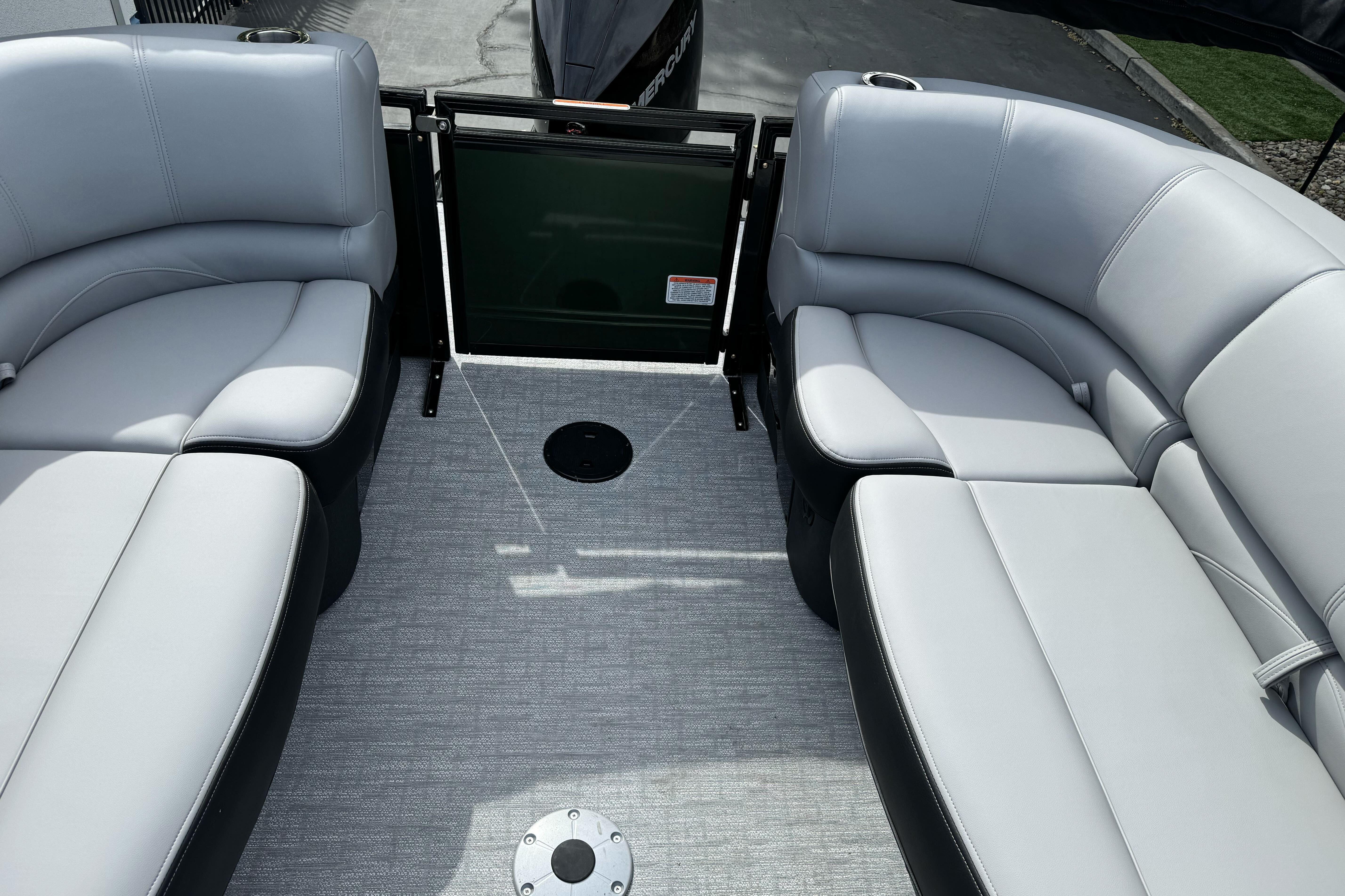 2026 Regency 250 DL boat interior with gray seating and carpeted flooring.