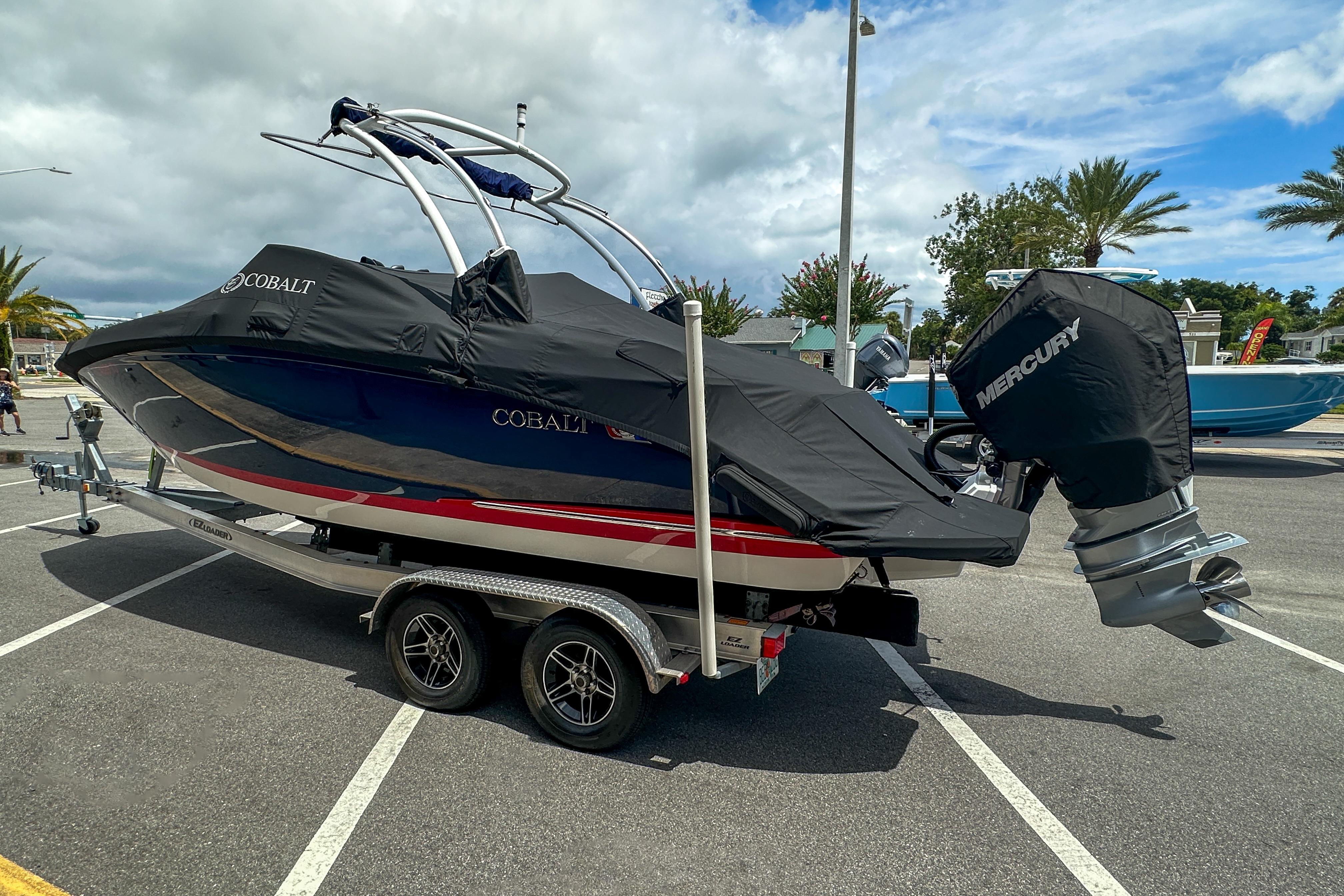 2022 Cobalt 25SC boat on trailer, covered, with Mercury engine, parked outdoors.