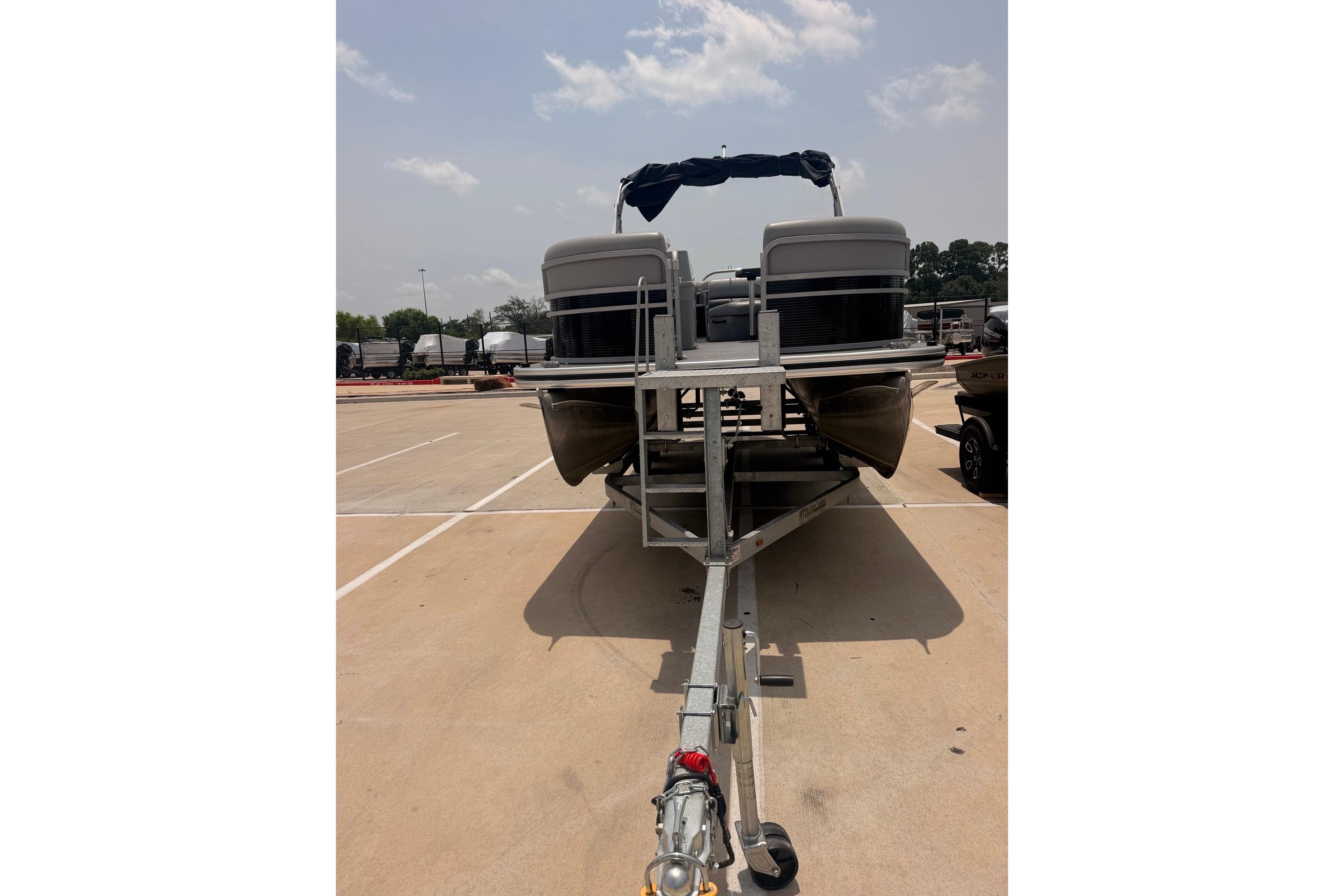 2021 Lowe SS 210 pontoon boat on trailer in parking lot.