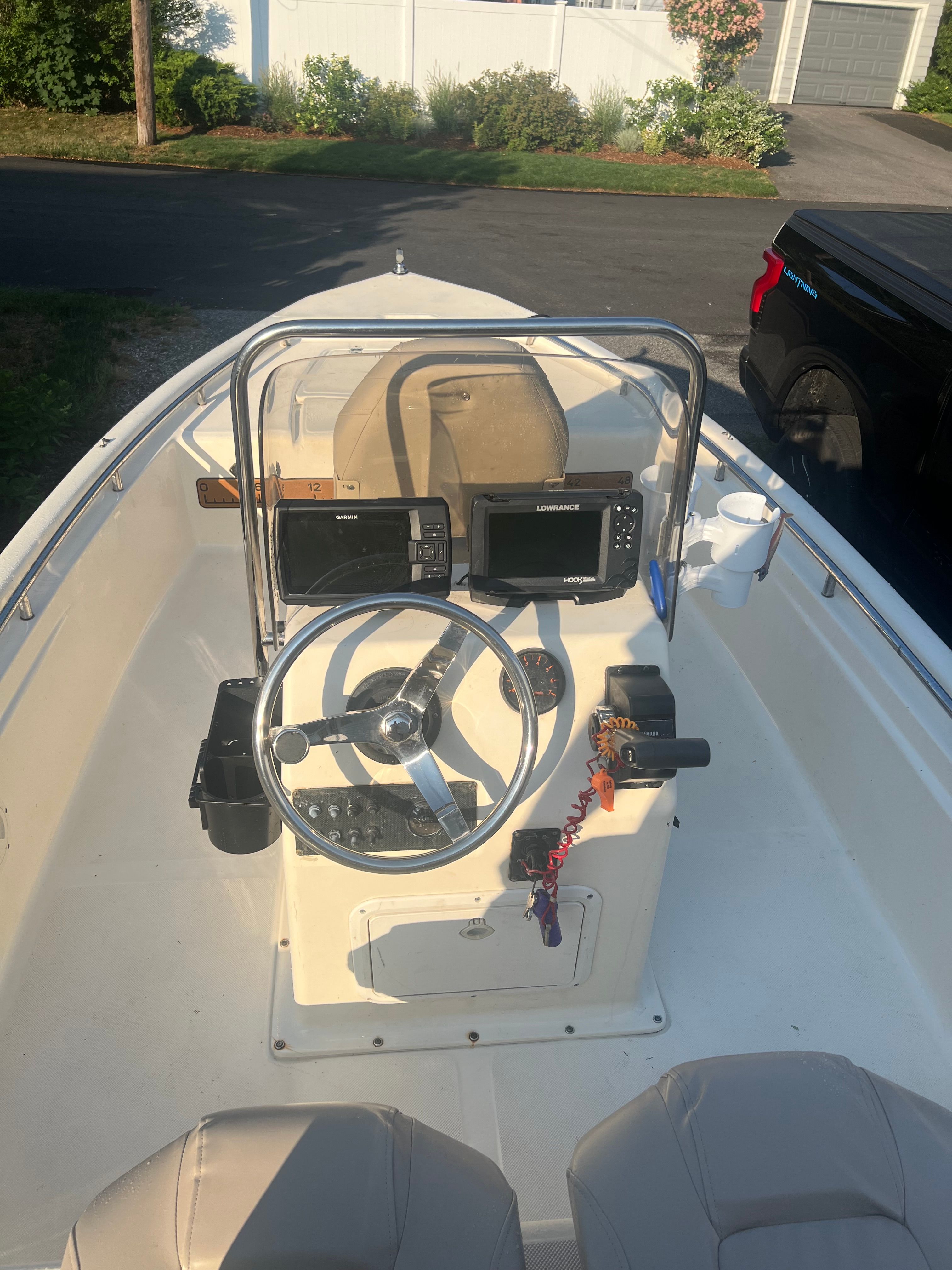 The image shows the cockpit of a 2001 Scout 151 Sportfish with steering wheel and electronics.