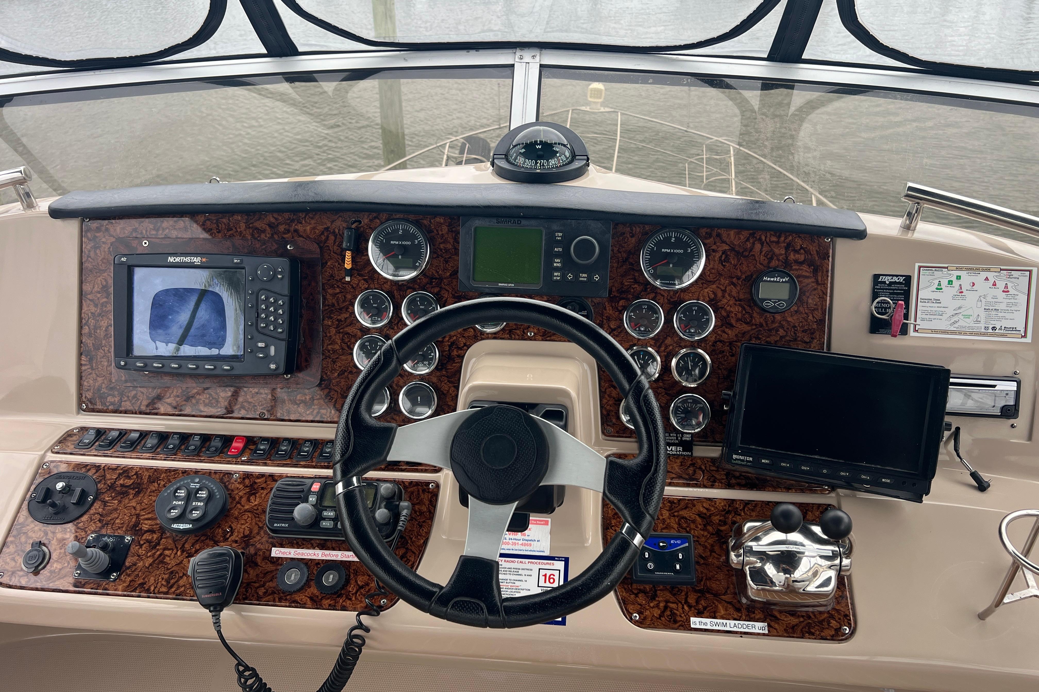 2006 Carver 43 Motor Yacht helm with navigation instruments and steering wheel.