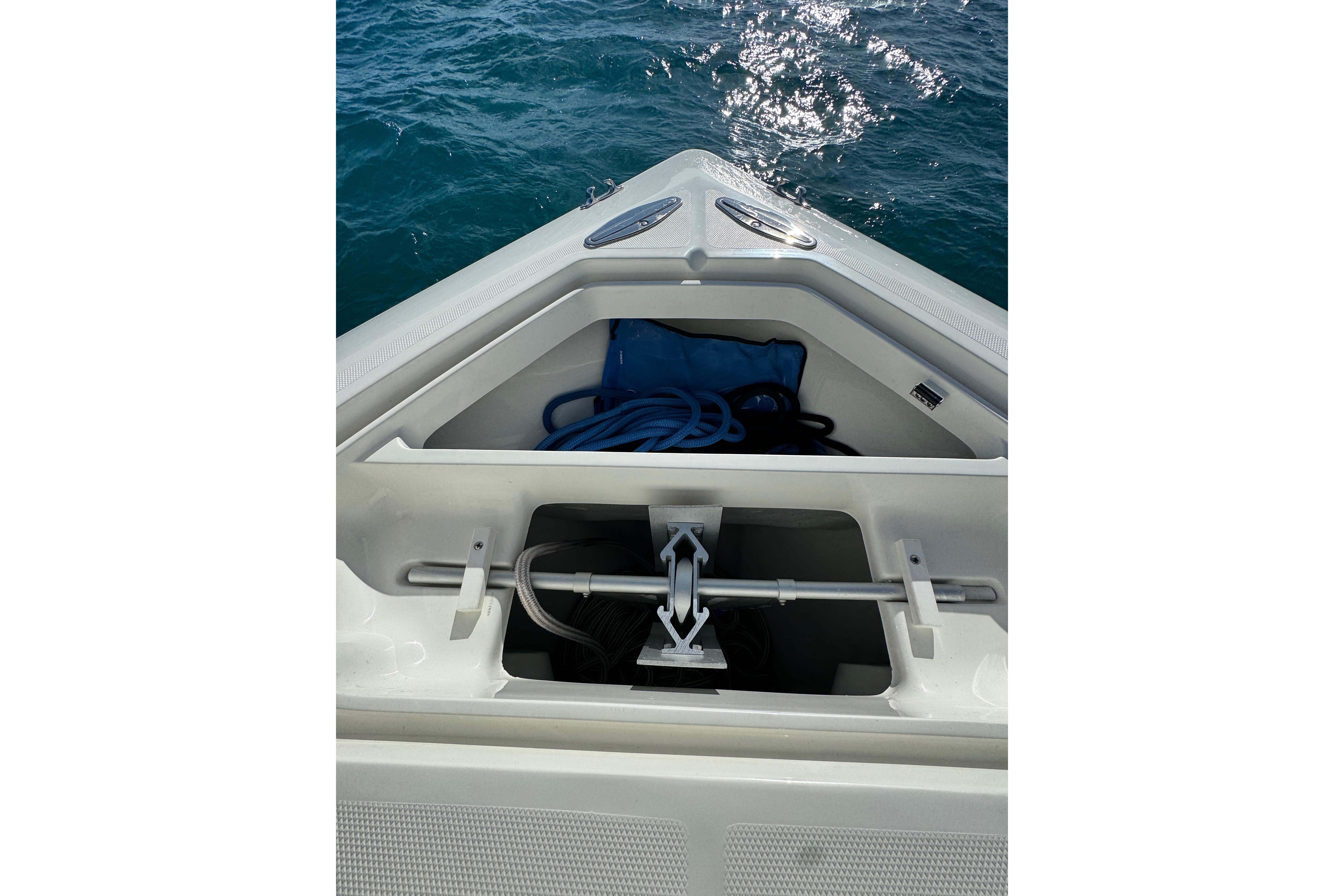 Bow storage compartment of 2021 SeaVee Boats 370Z with anchor and rope.