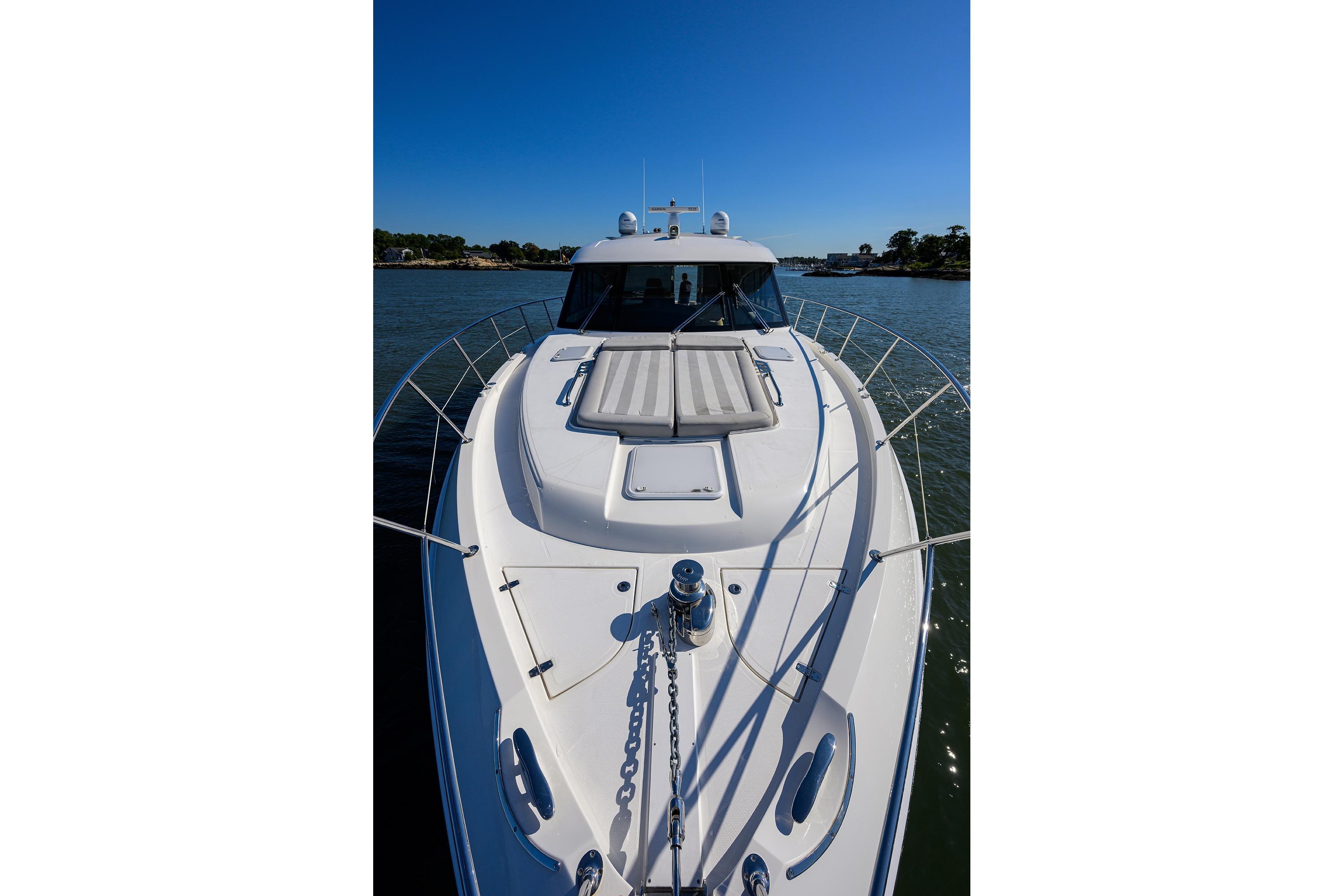 2019 Riviera 5400 Sport Yacht on calm water, showcasing sleek design and spacious deck.
