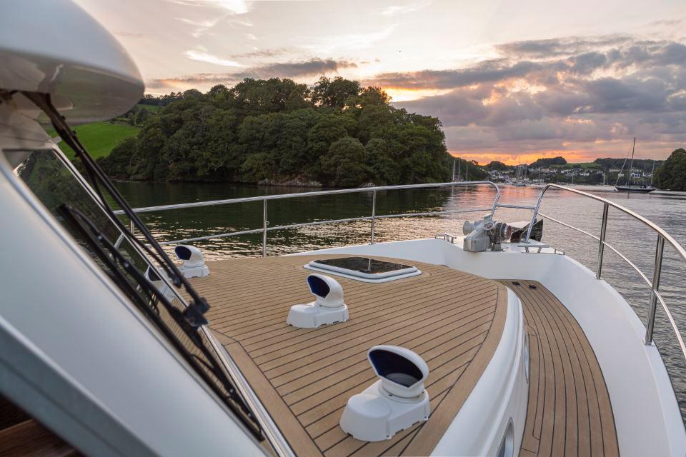 Hardy Commodore 42 yacht deck at sunset, 2002 model, with scenic water and island view.