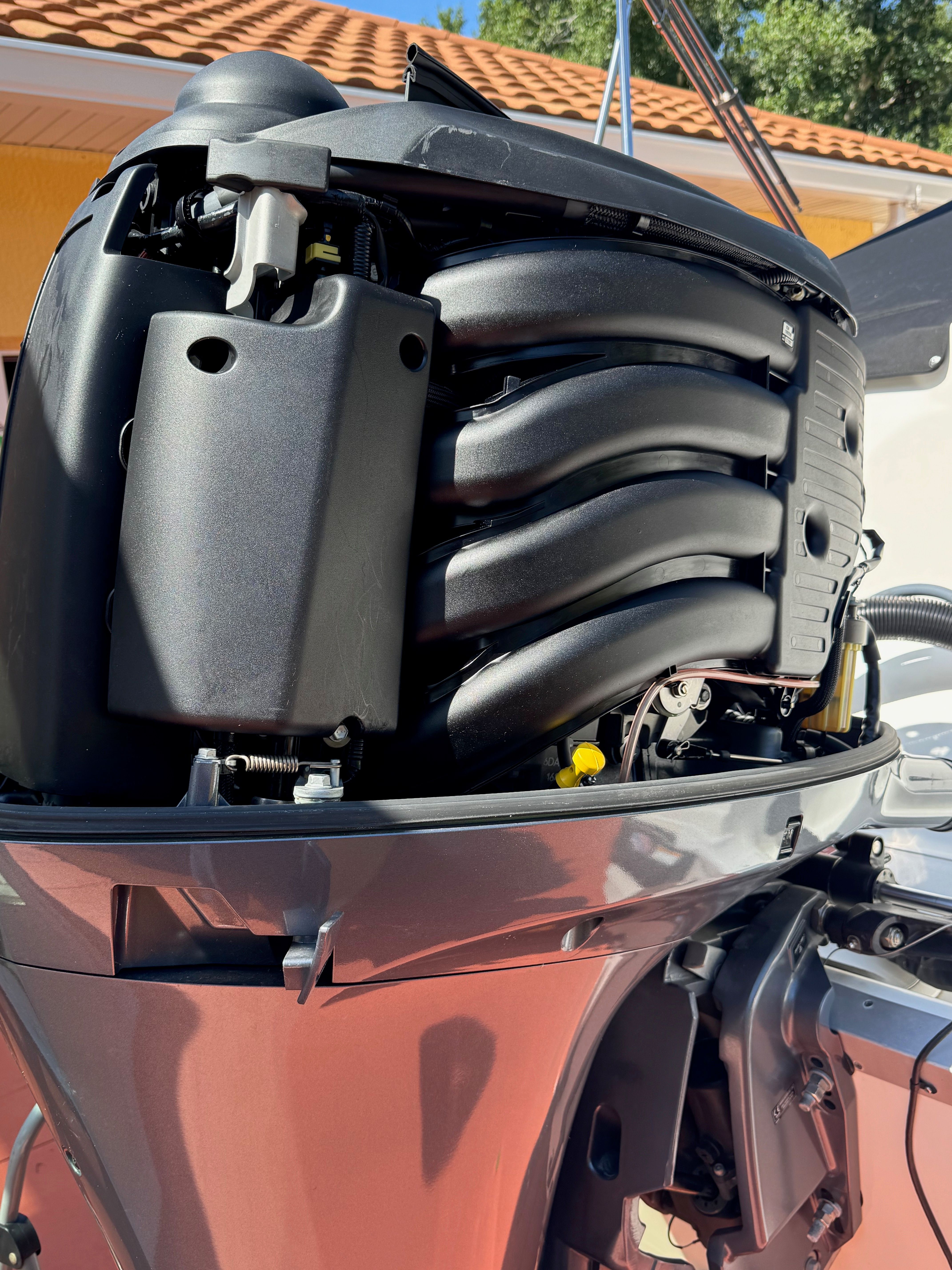 Close-up of an outboard motor with visible components and wiring.