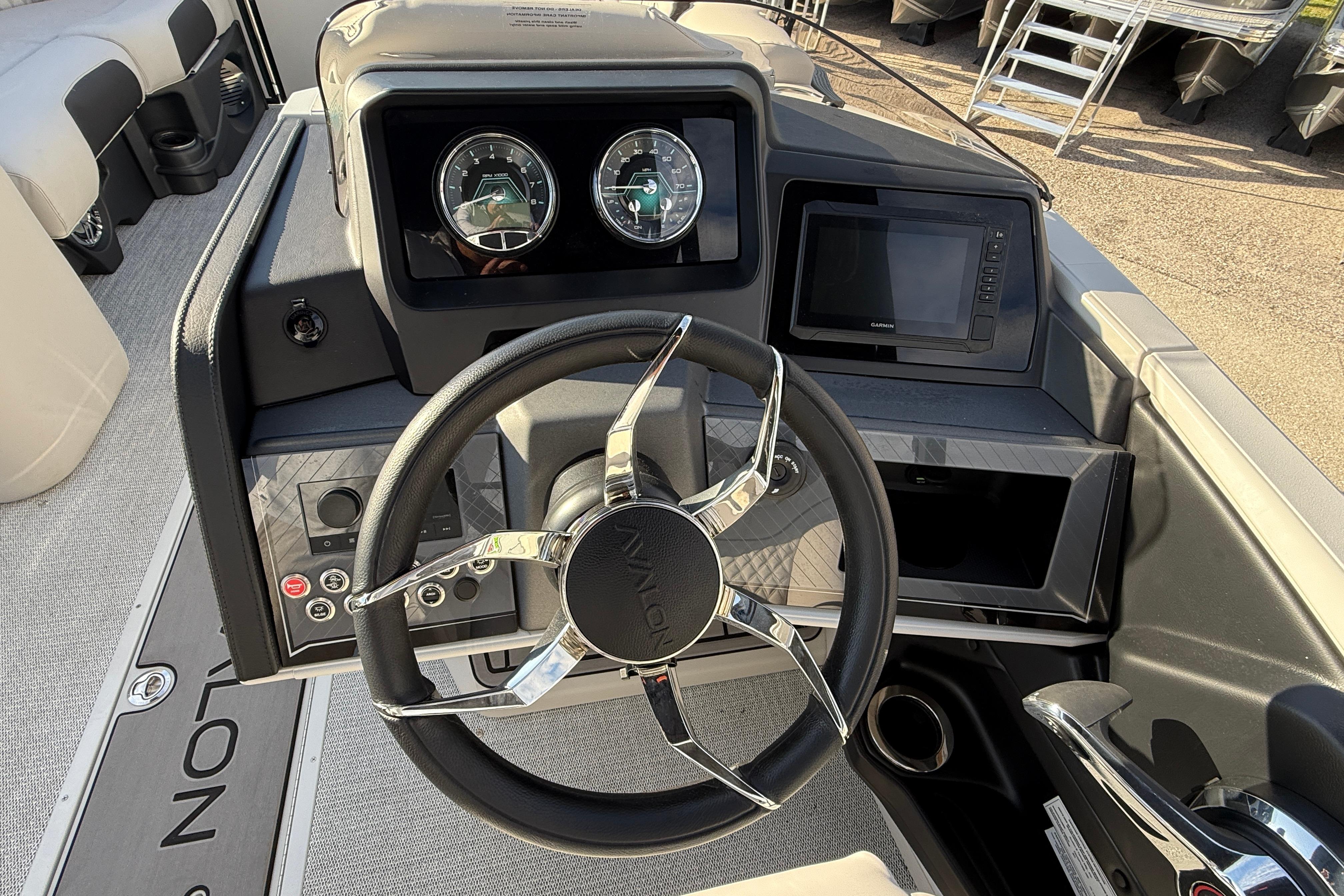 Steering console of 2026 Avalon 2385 Catalina Quad Lounger, featuring modern controls and gauges.