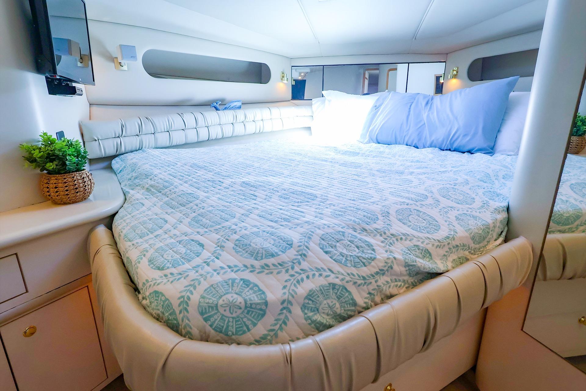 Luxurious bedroom interior of 1998 Sea Ray 500 Sundancer yacht with elegant bedding.