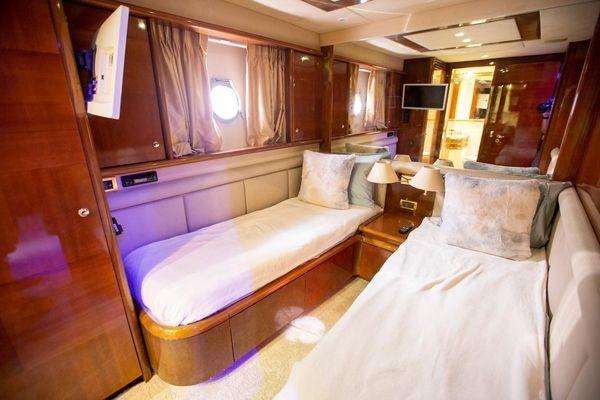 Luxurious cabin interior of 2003 Azimut 74 Solar yacht with twin beds and elegant decor.