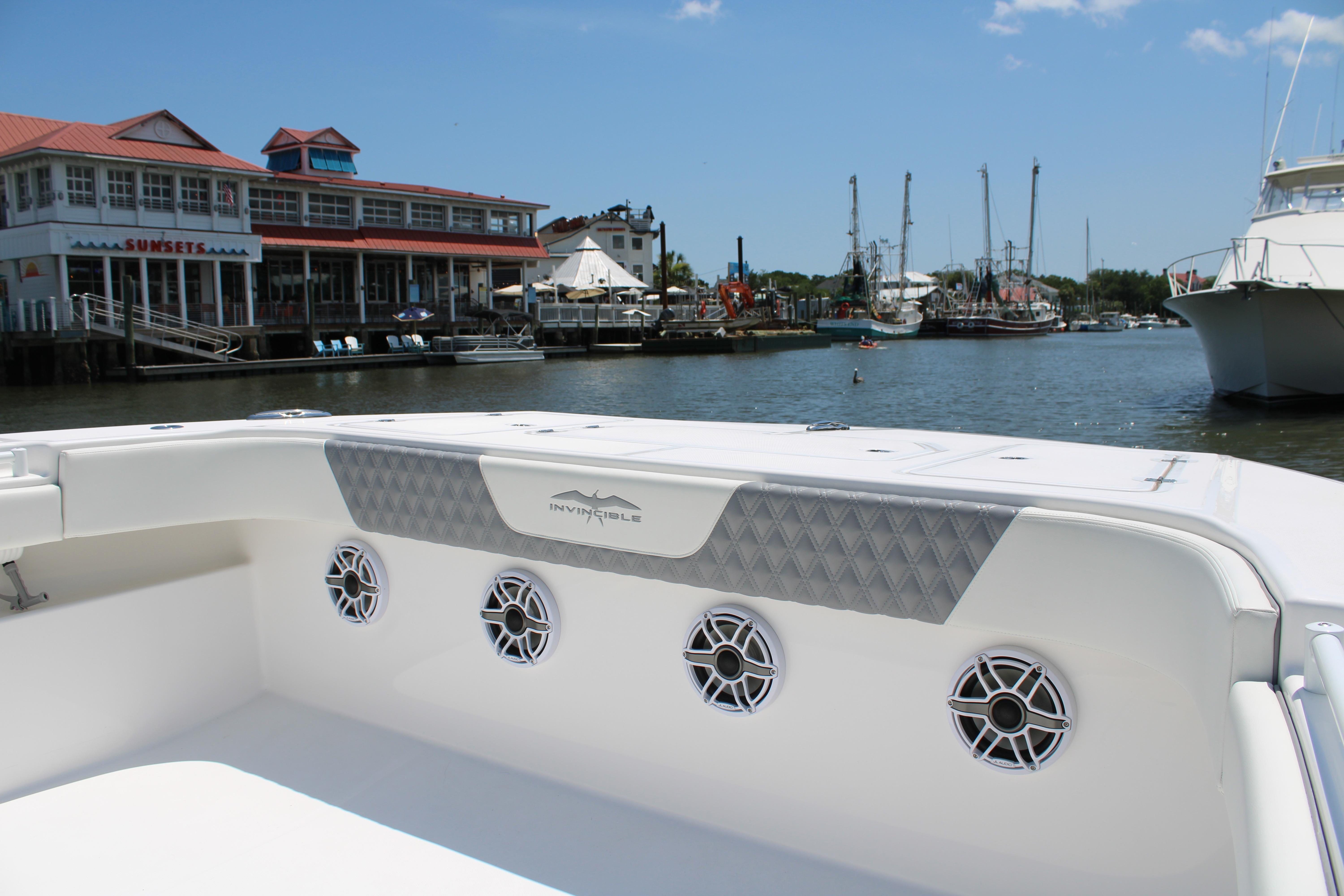 2025 Invincible 35 Catamaran docked near waterfront buildings and boats.