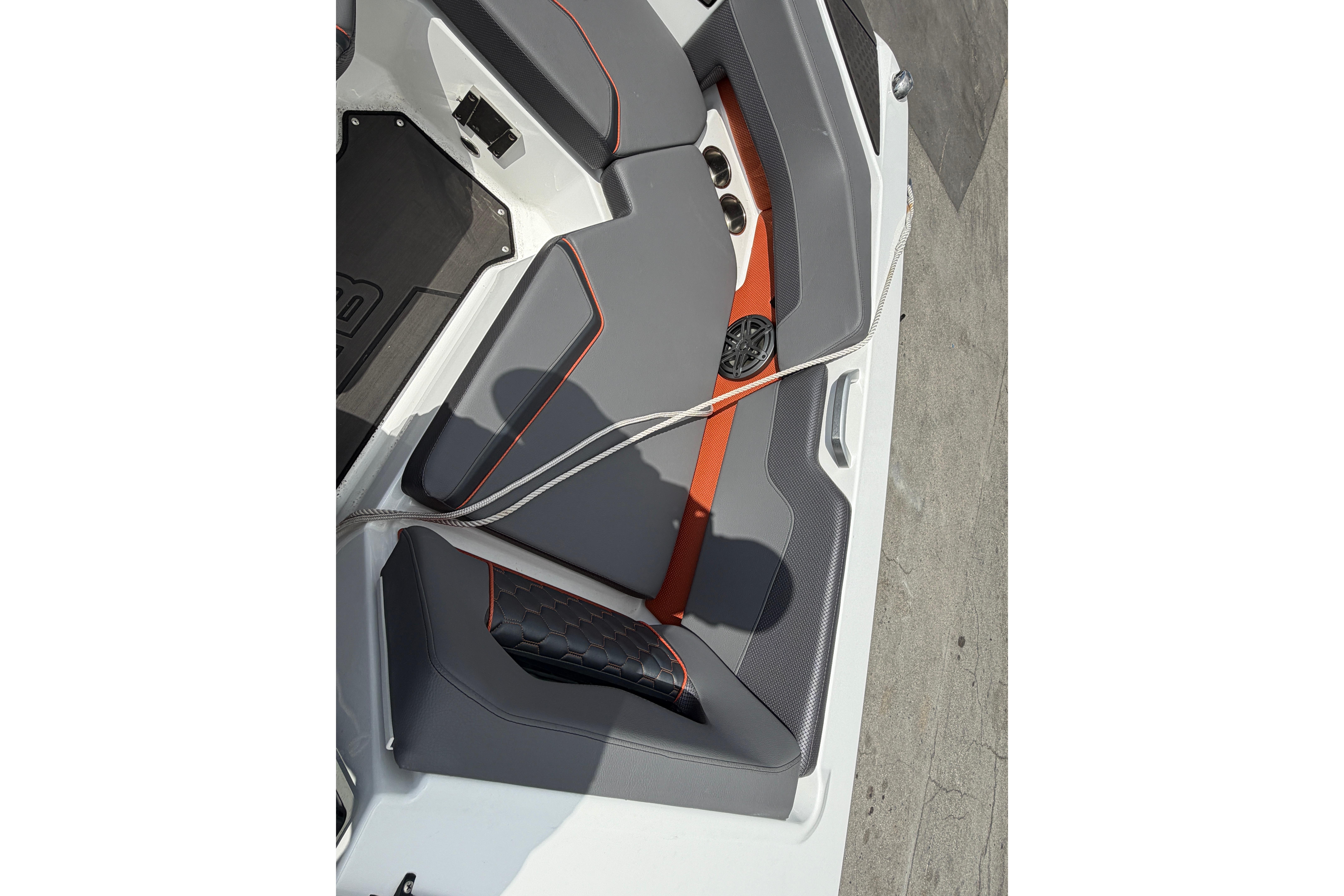 2026 Scarab 235 LX boat interior with gray and orange seating, featuring modern design elements.