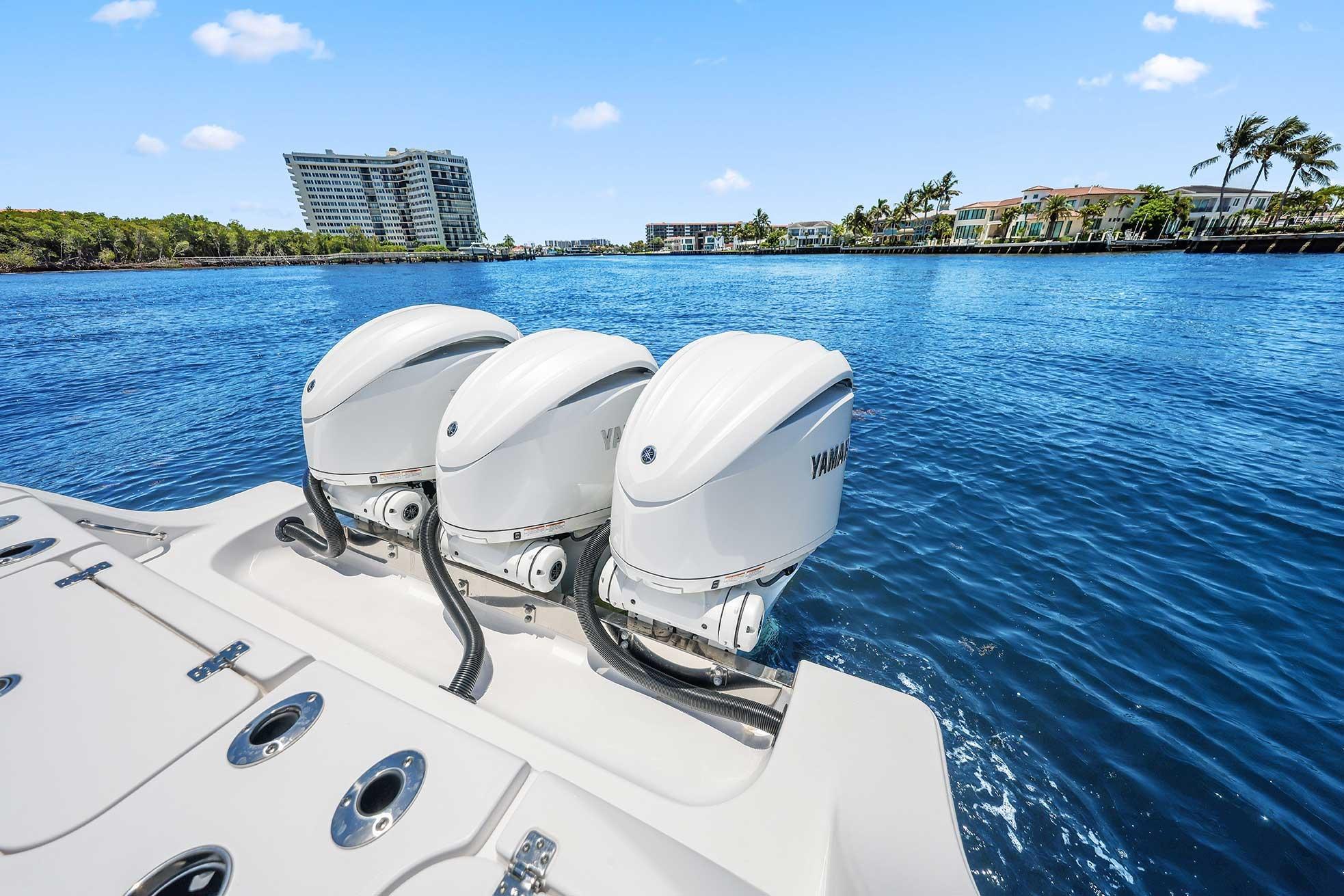 2024 Sportsman Open 352 Center Console with triple Yamaha outboard engines on blue water.