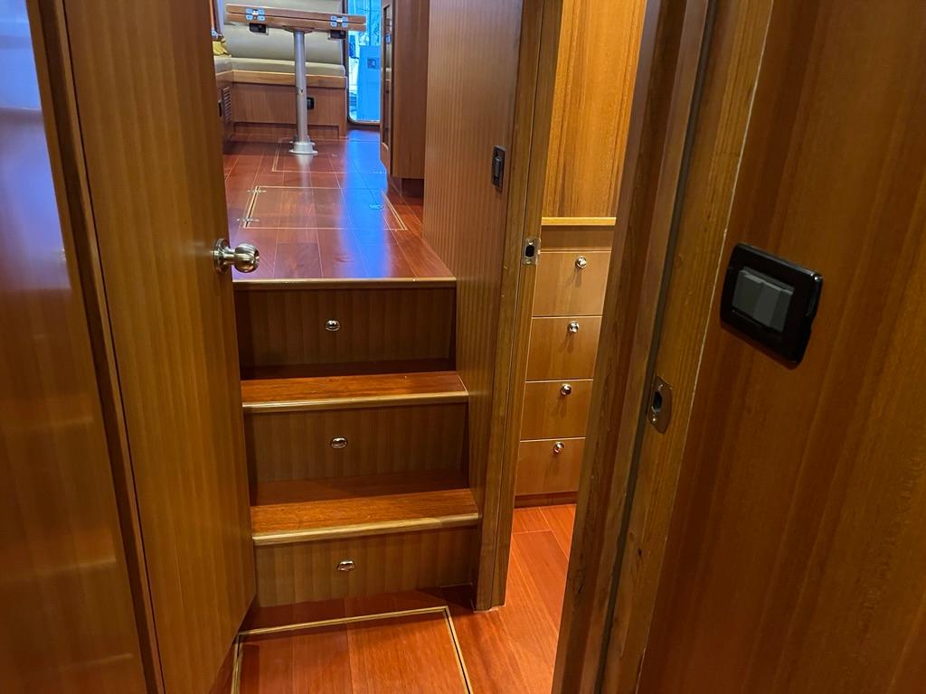 Interior of 2025 Bracewell 41 yacht with wooden stairs and cabinetry.