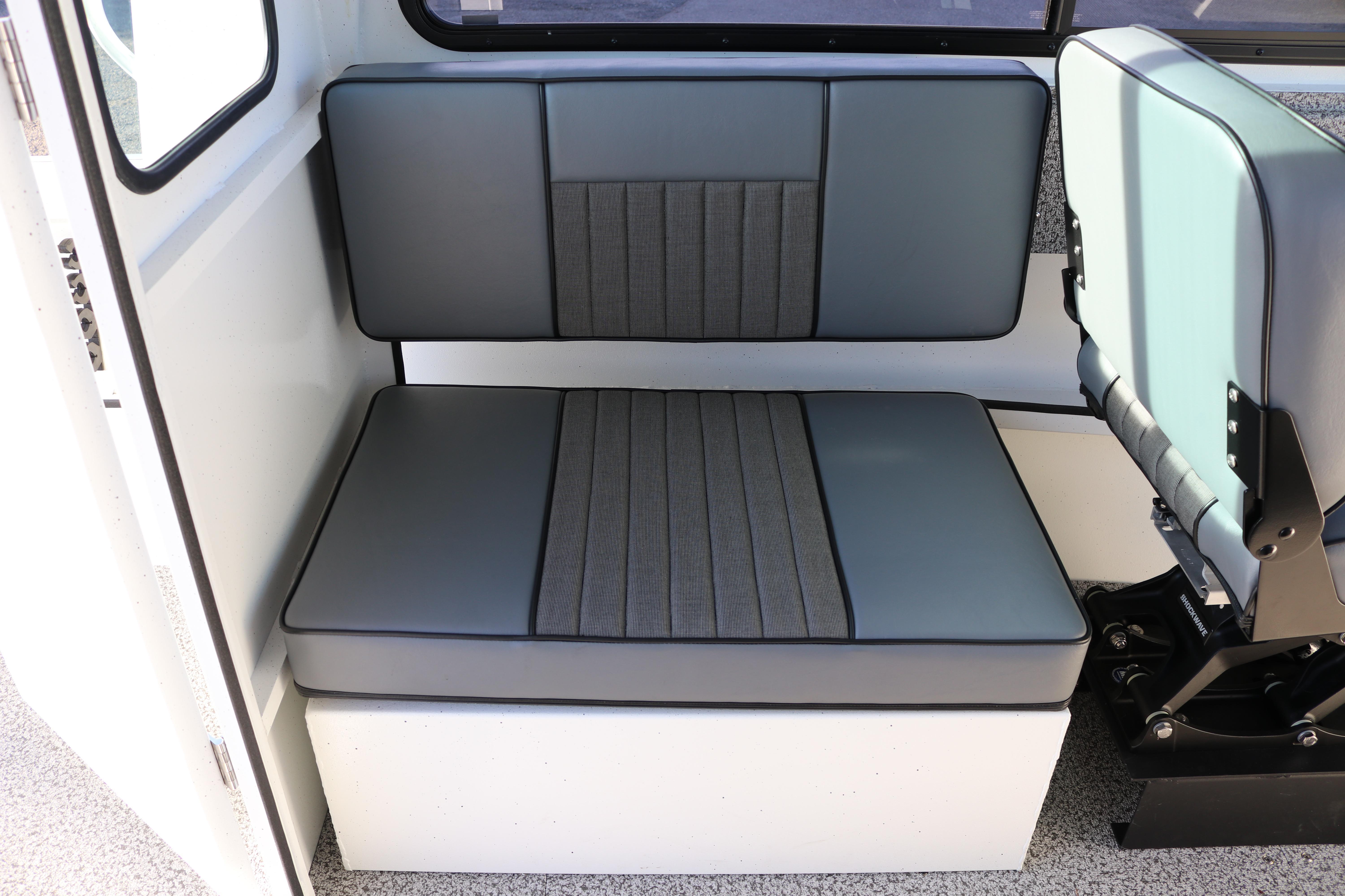 2026 Alumaweld Intruder Outboard 22 interior seating, featuring gray cushioned bench and chair.