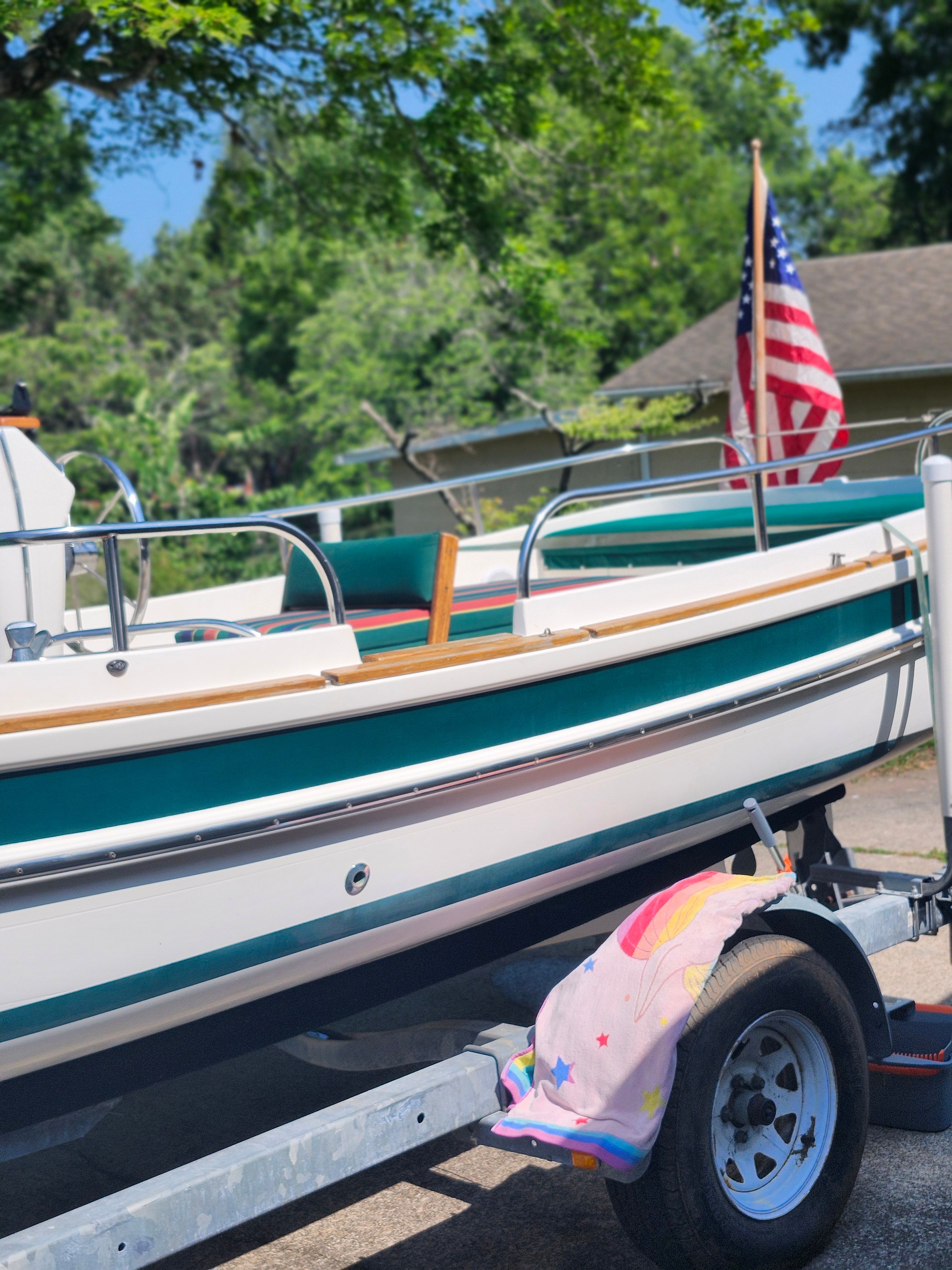 Ranger Tugs Martini 21 Launch from 2000 on a trailer with a US flag.