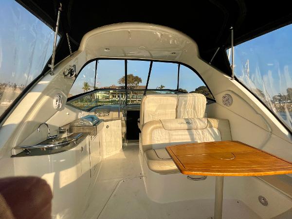 Interior of 2014 Sea Ray 330 Sundancer yacht with seating and table.