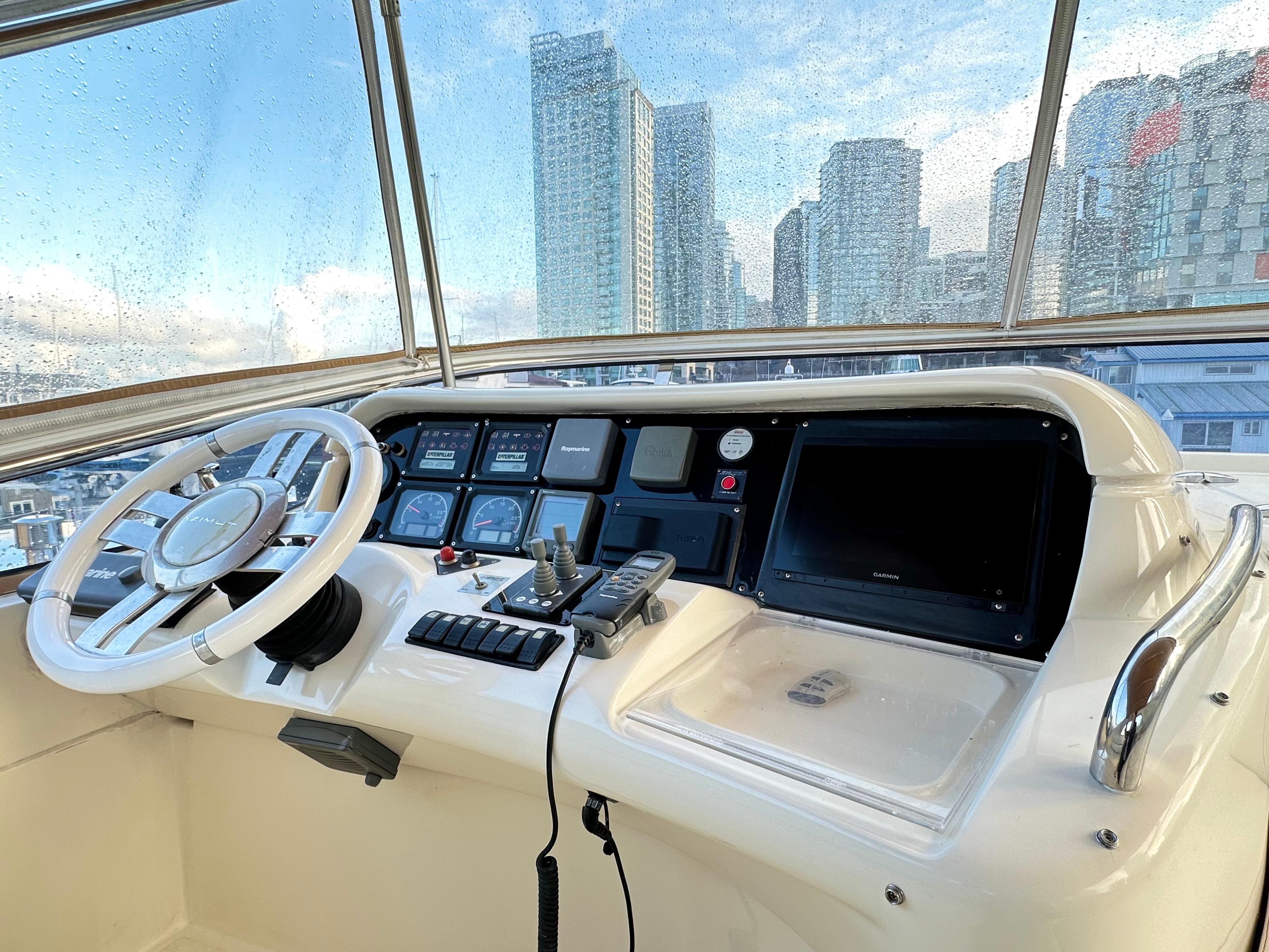 Cockpit of 2011 Azimut 55E yacht with city skyline view.