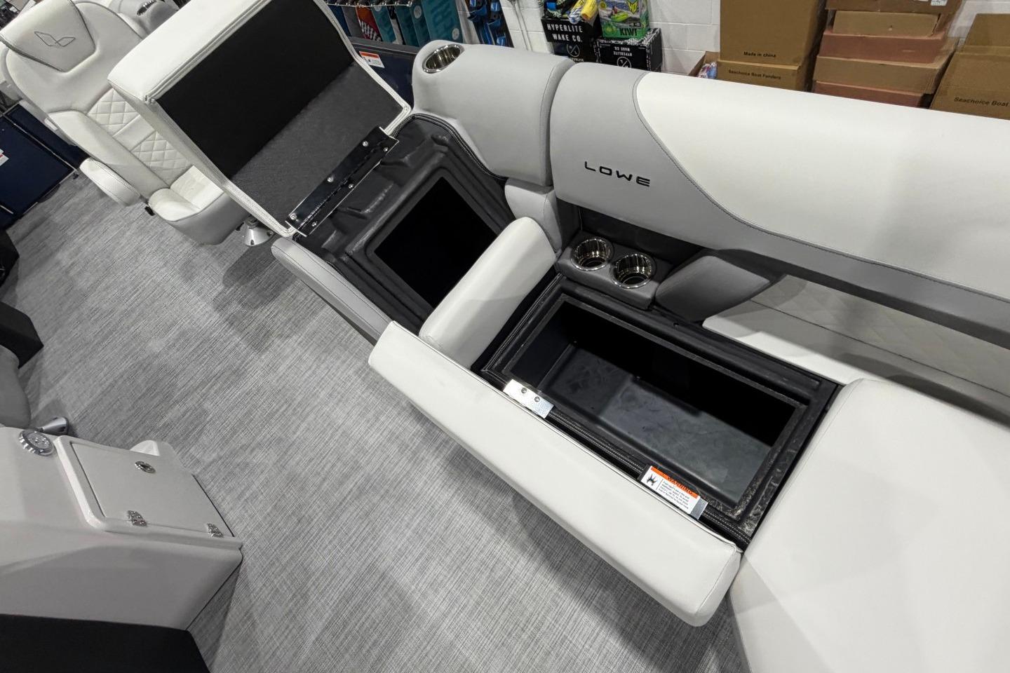 Interior of 2026 Lowe SS 230 WT boat with open storage compartments and cup holders.