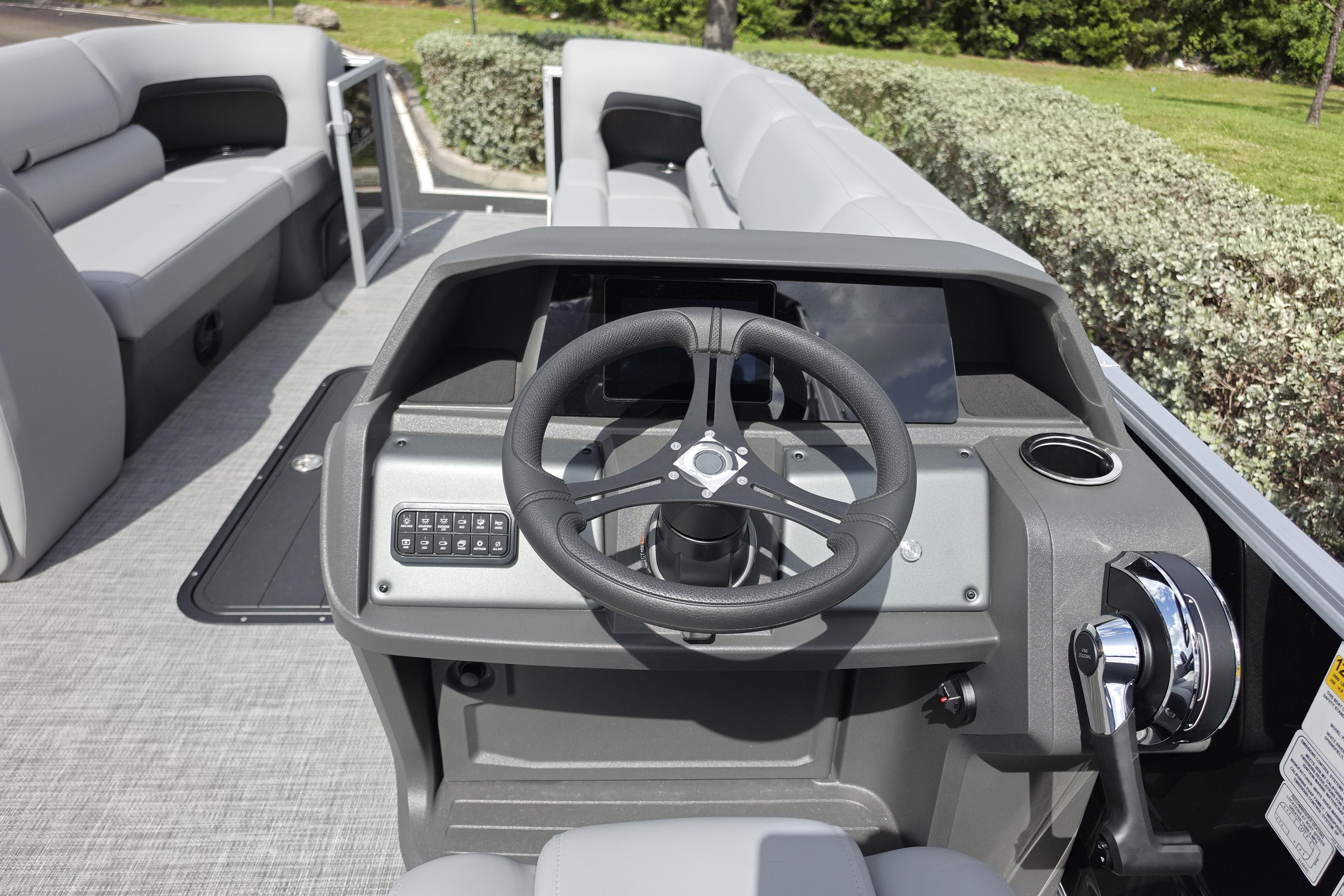 2026 Sun Tracker Party Barge 24 XP3 interior with steering wheel and seating.