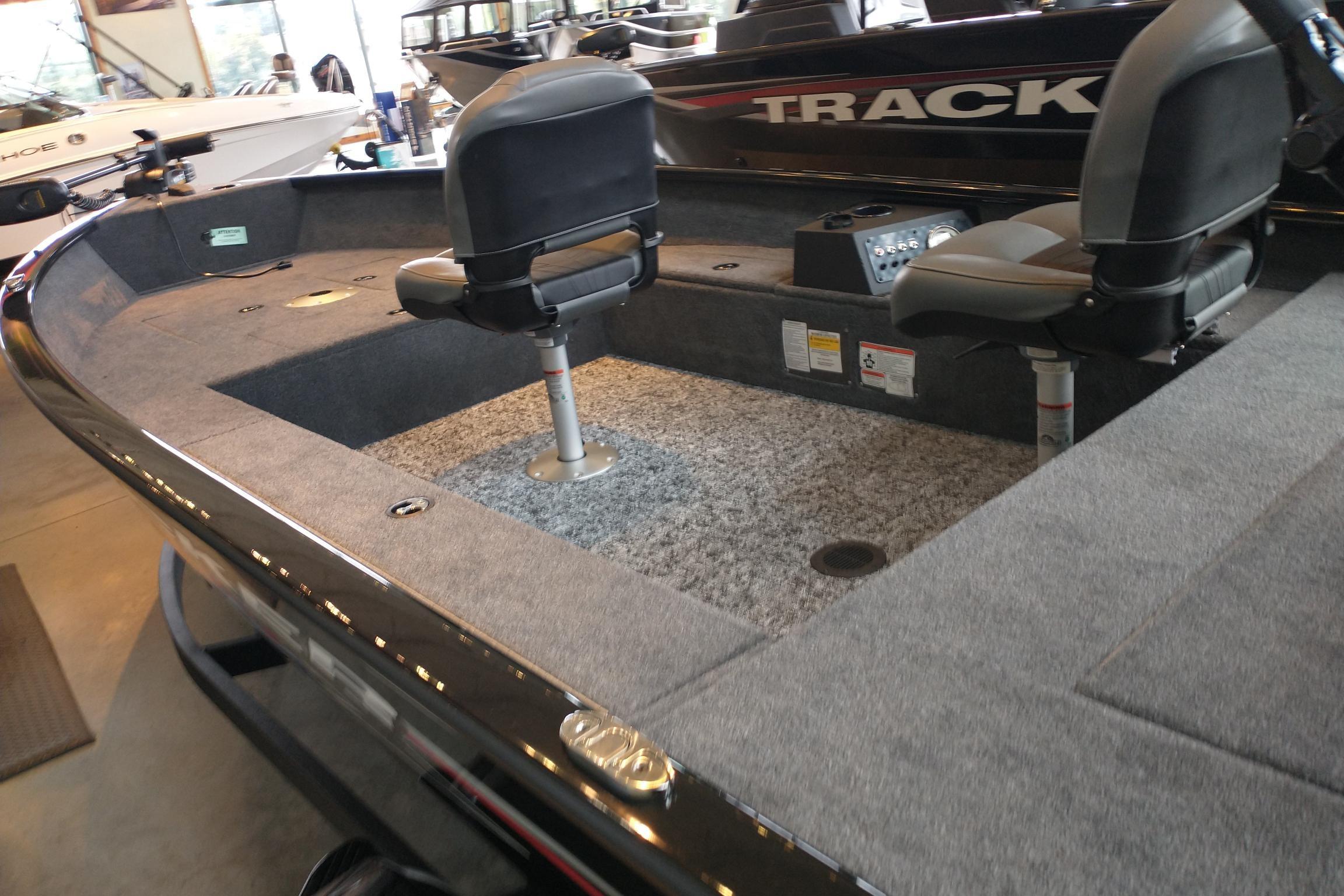 2025 Tracker Super Guide V-16 T boat interior with seating and carpeted deck.