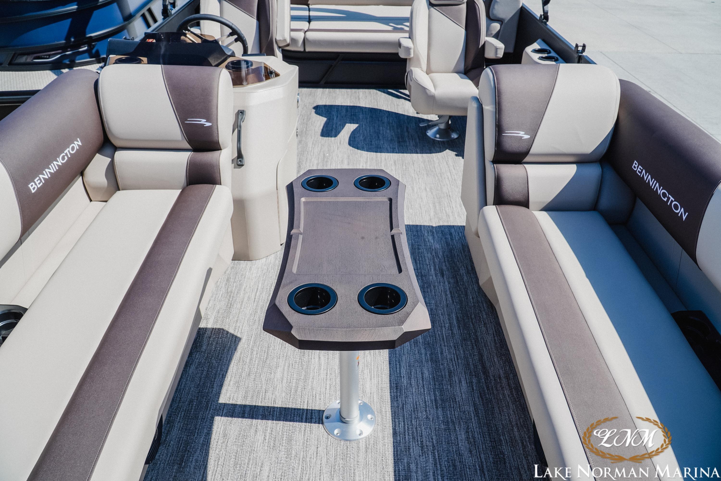 Interior of 2027 Bennington 23ssb pontoon boat with seating and table, Lake Norman Marina.