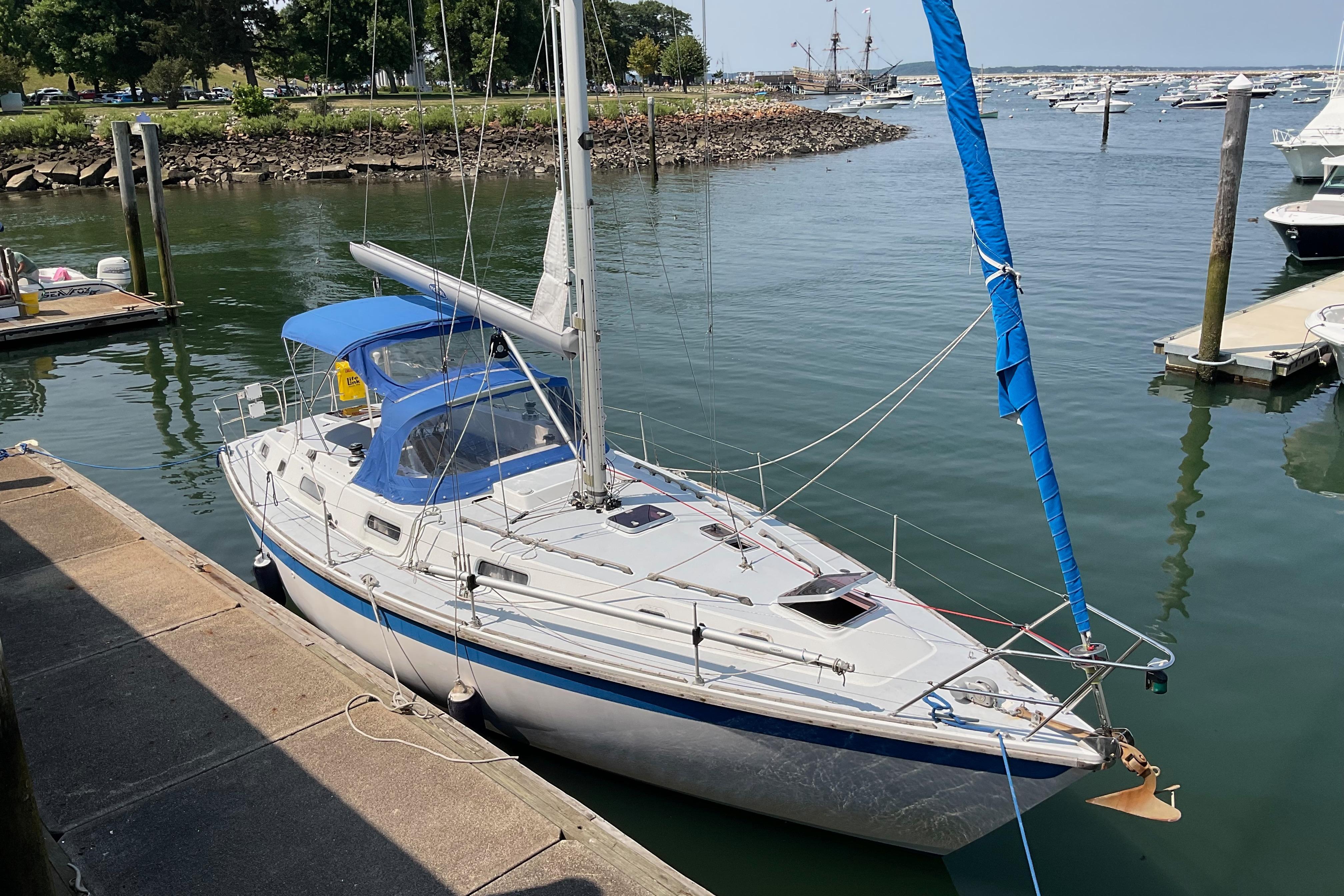1988 Westerly Corsair 36 sailboat docked in a marina, featuring blue accents.