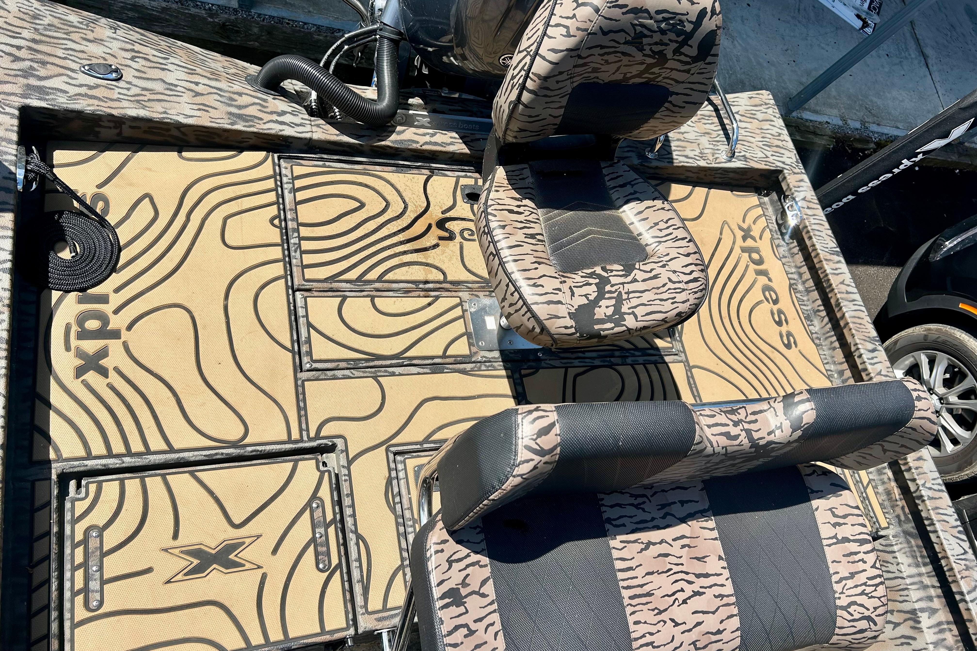 2025 Xpress H22B Bay boat interior with camo-patterned seats and deck design.