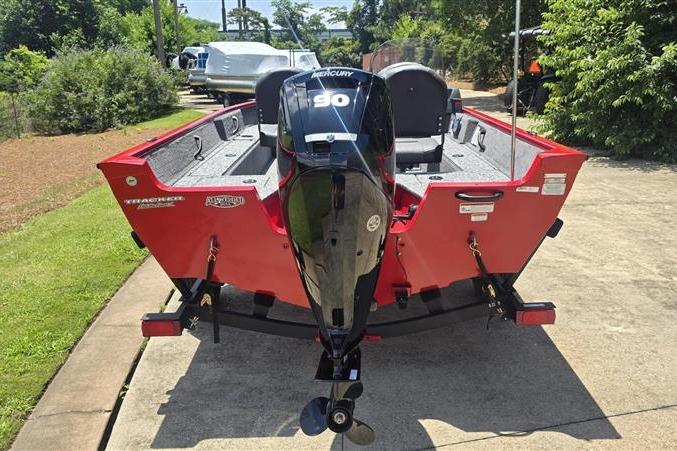 2026 Tracker Pro Guide V-16 SC boat with Mercury 90 engine, parked outdoors.