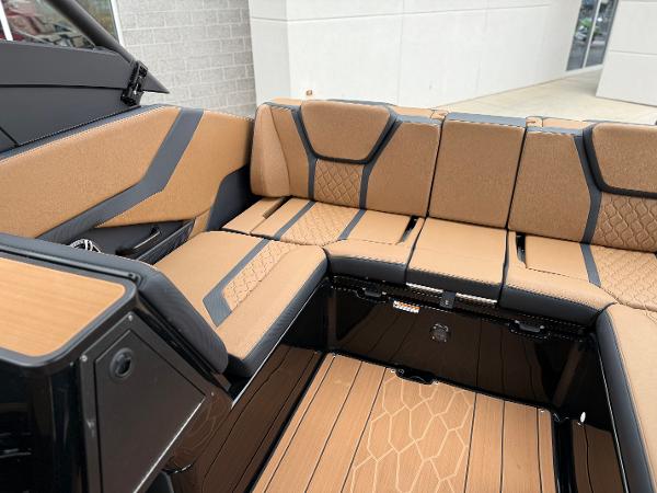 2025 Yamaha Boats 255XD interior with tan and black seating, modern design.
