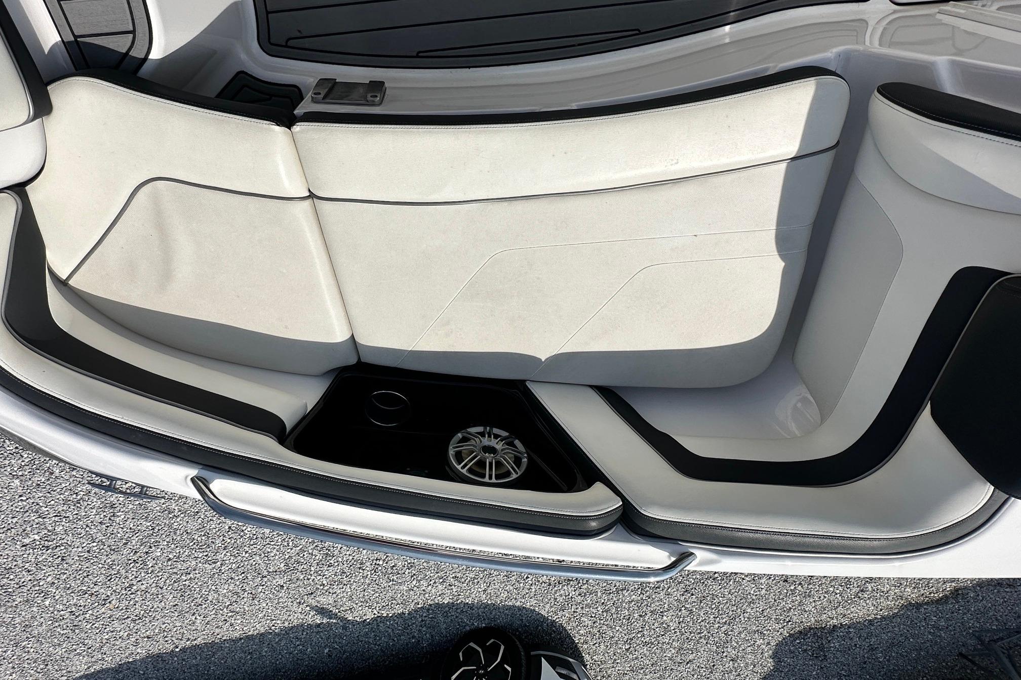 Interior seating of 2016 Yamaha 242 Limited S boat, featuring sleek white and black design.