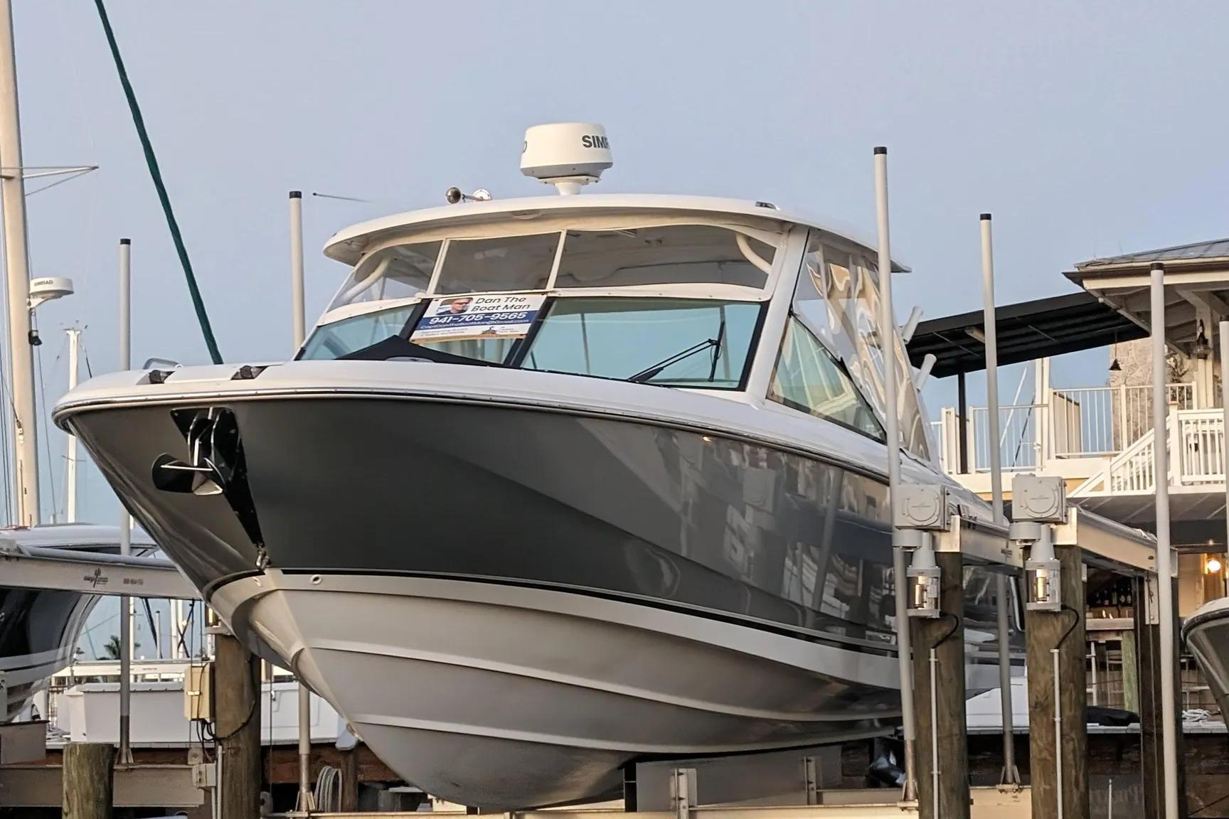 2017 Boston Whaler 320 Vantage boat docked at marina, showcasing sleek design and modern features.