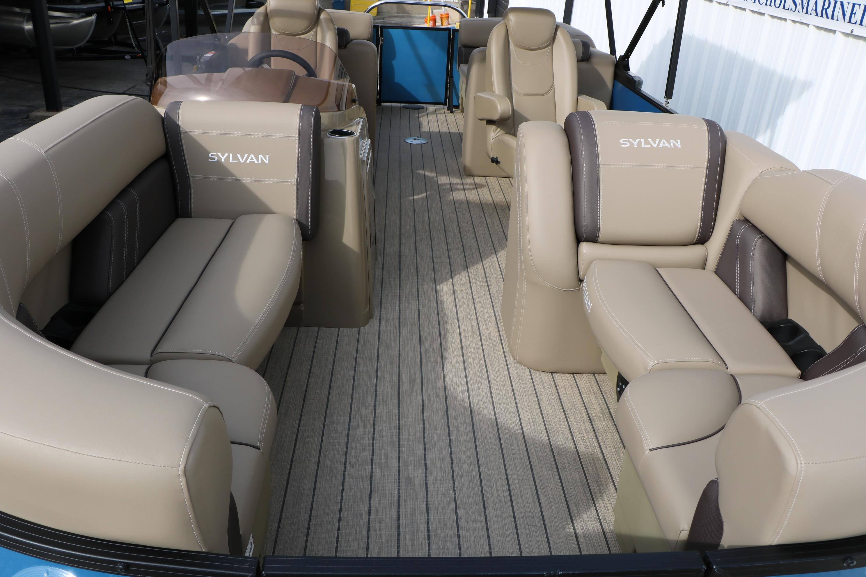 2026 Sylvan Mirage 822 LZ pontoon boat interior with beige seating and steering console.