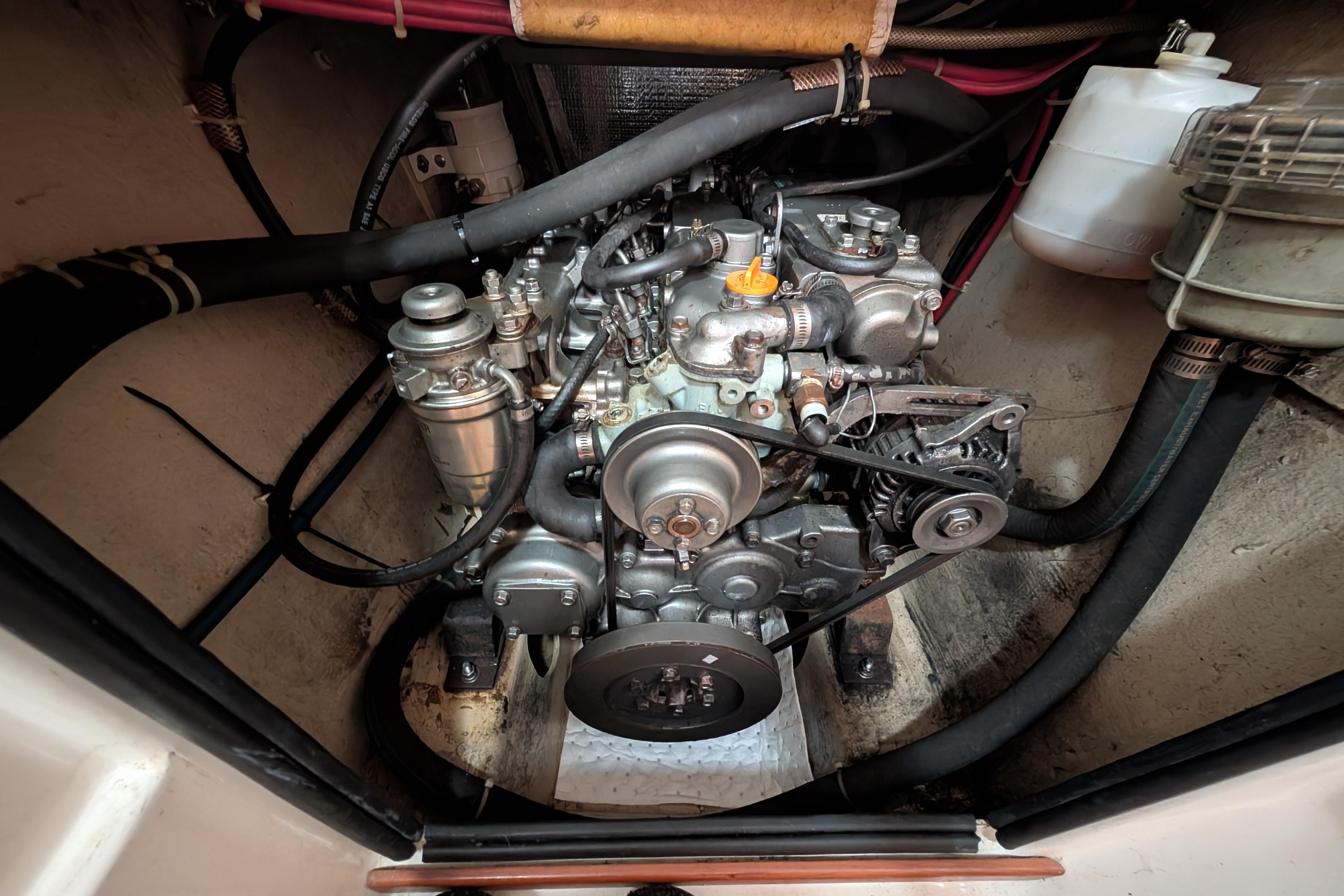Engine compartment of 2004 PDQ 34 Powercat, showcasing mechanical components and hoses.