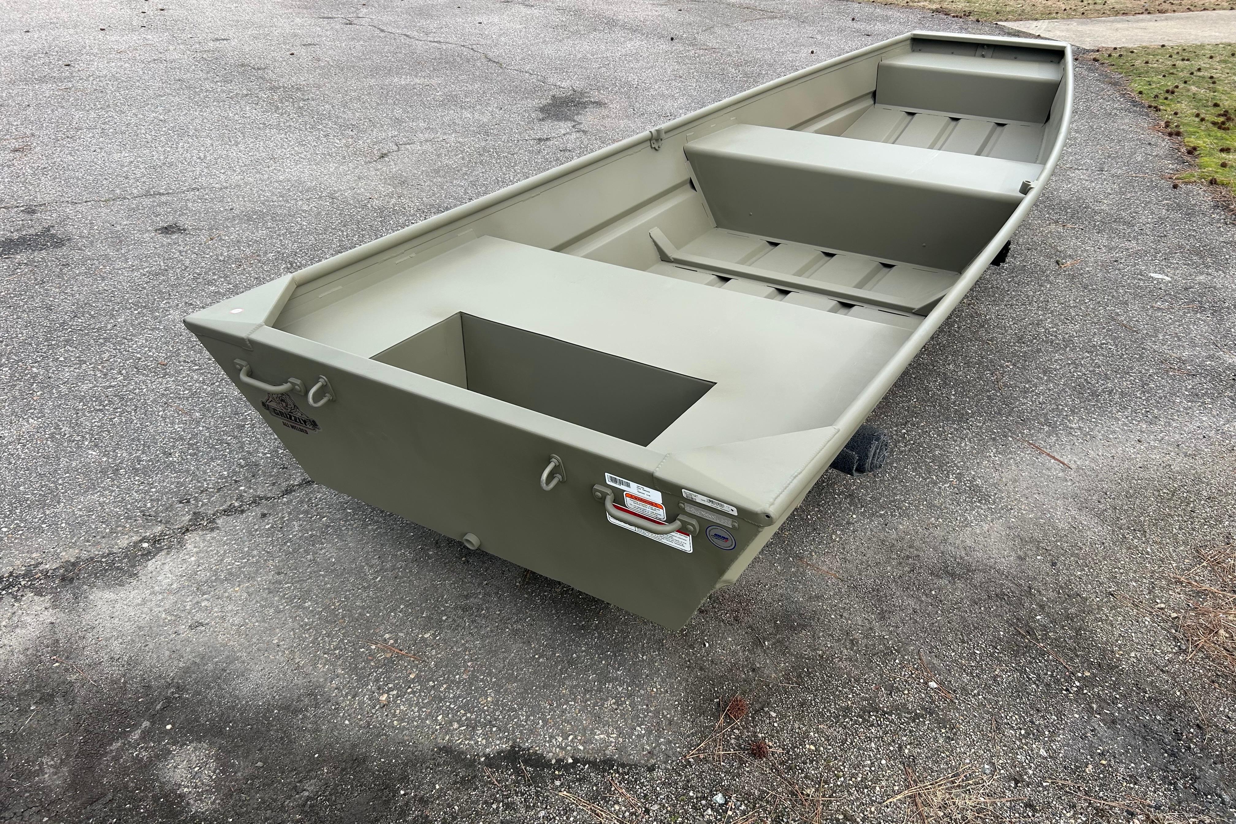 2026 Tracker Grizzly 14 Jon boat on pavement, showcasing its sturdy design.