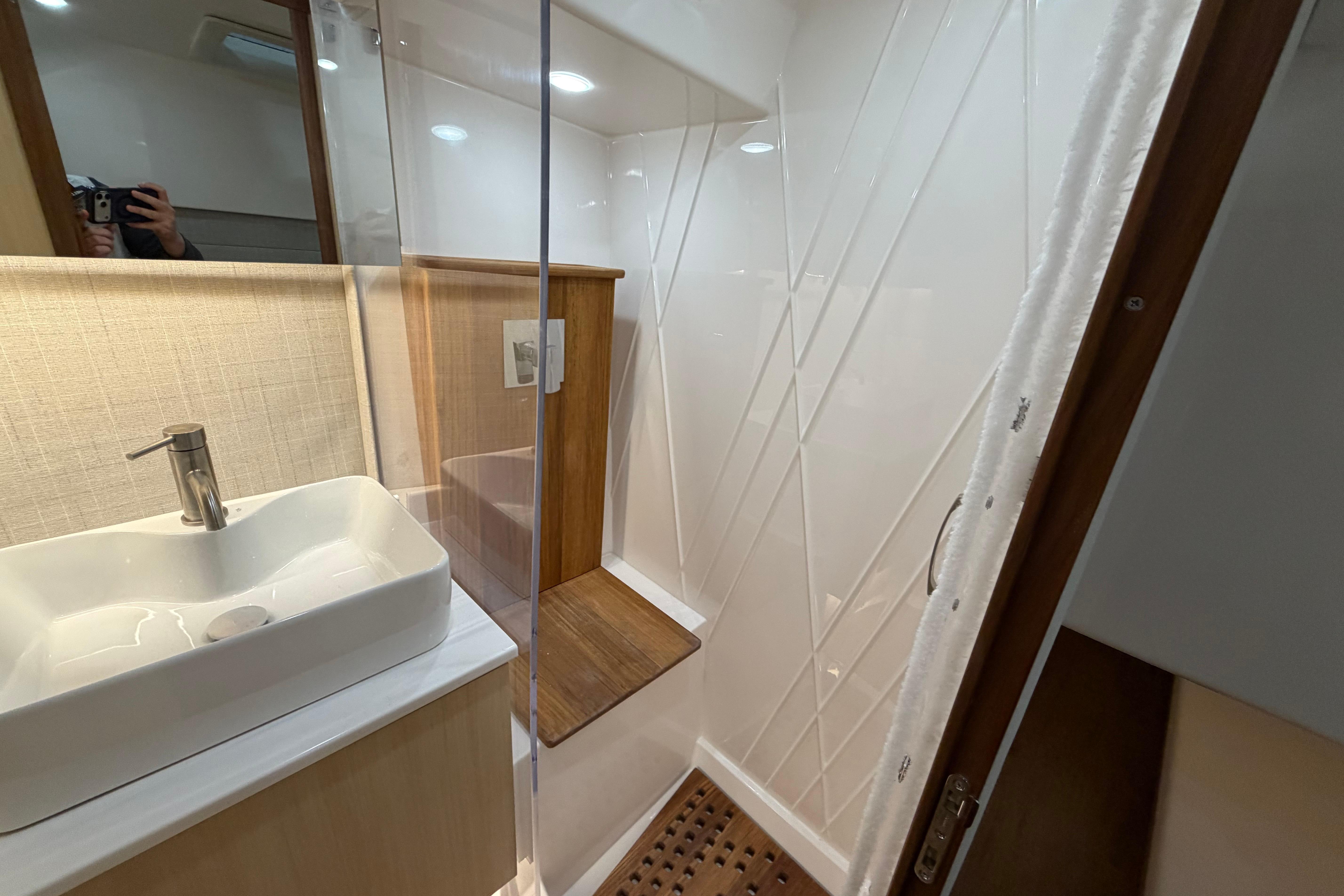 Modern bathroom interior of 2027 Regal 38 Surf yacht, featuring sleek sink and shower.