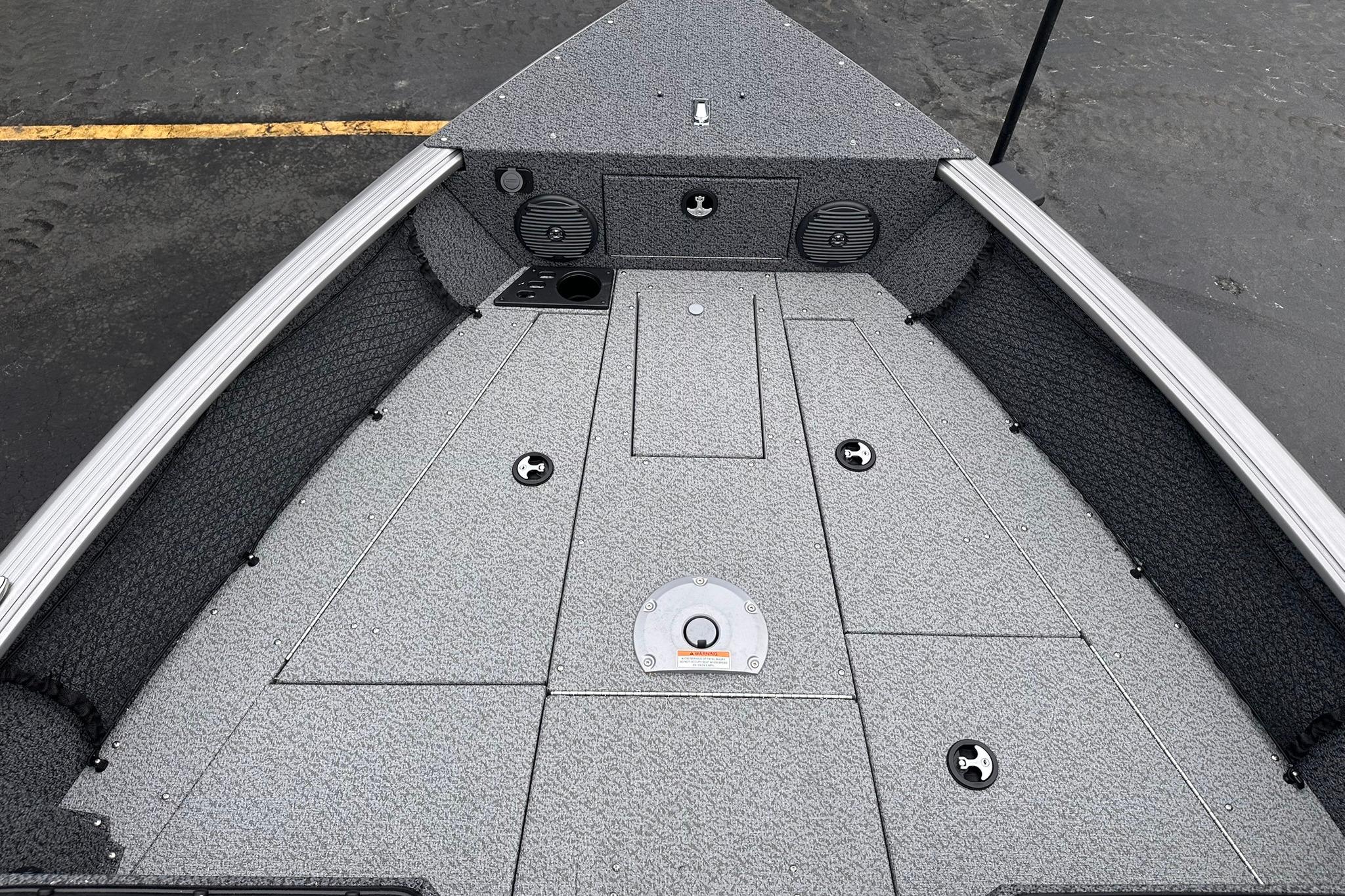 2026 Lund 1775 Impact XS Sport boat deck with storage compartments and speakers.
