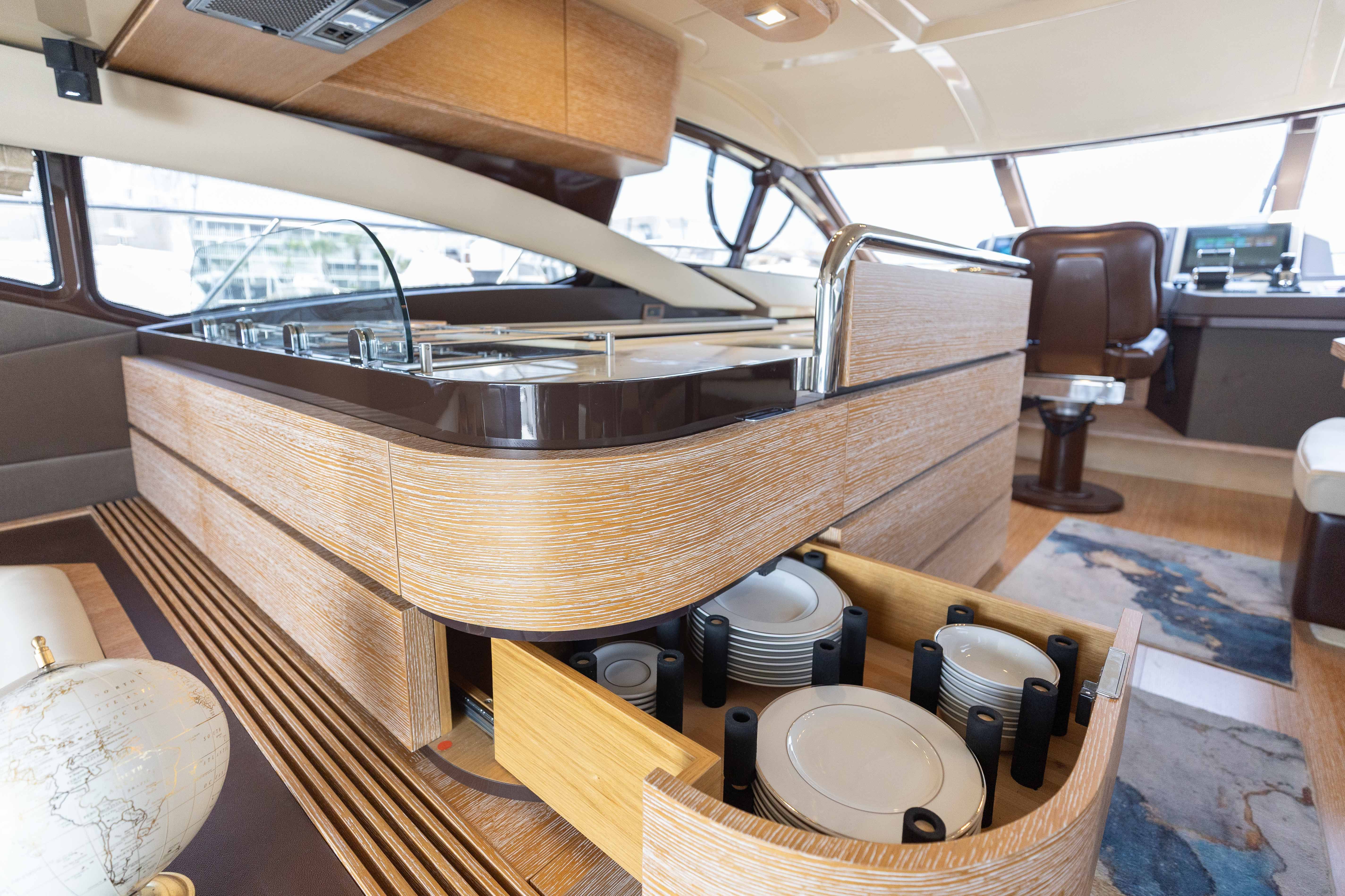 Luxurious interior of a 2014 Azimut 60 Flybridge yacht with modern kitchen and dining area.