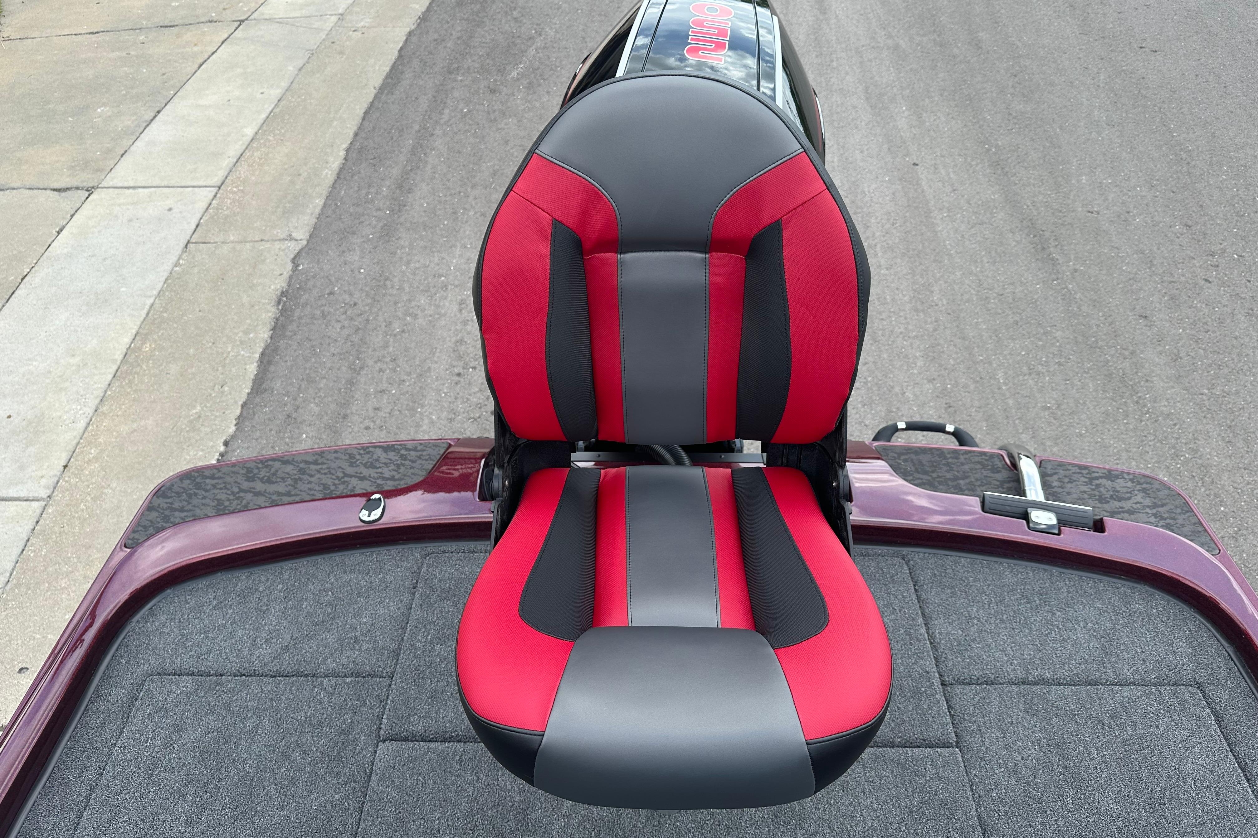 Red and black seat on 2026 Nitro Z21 XL boat, parked on a street.