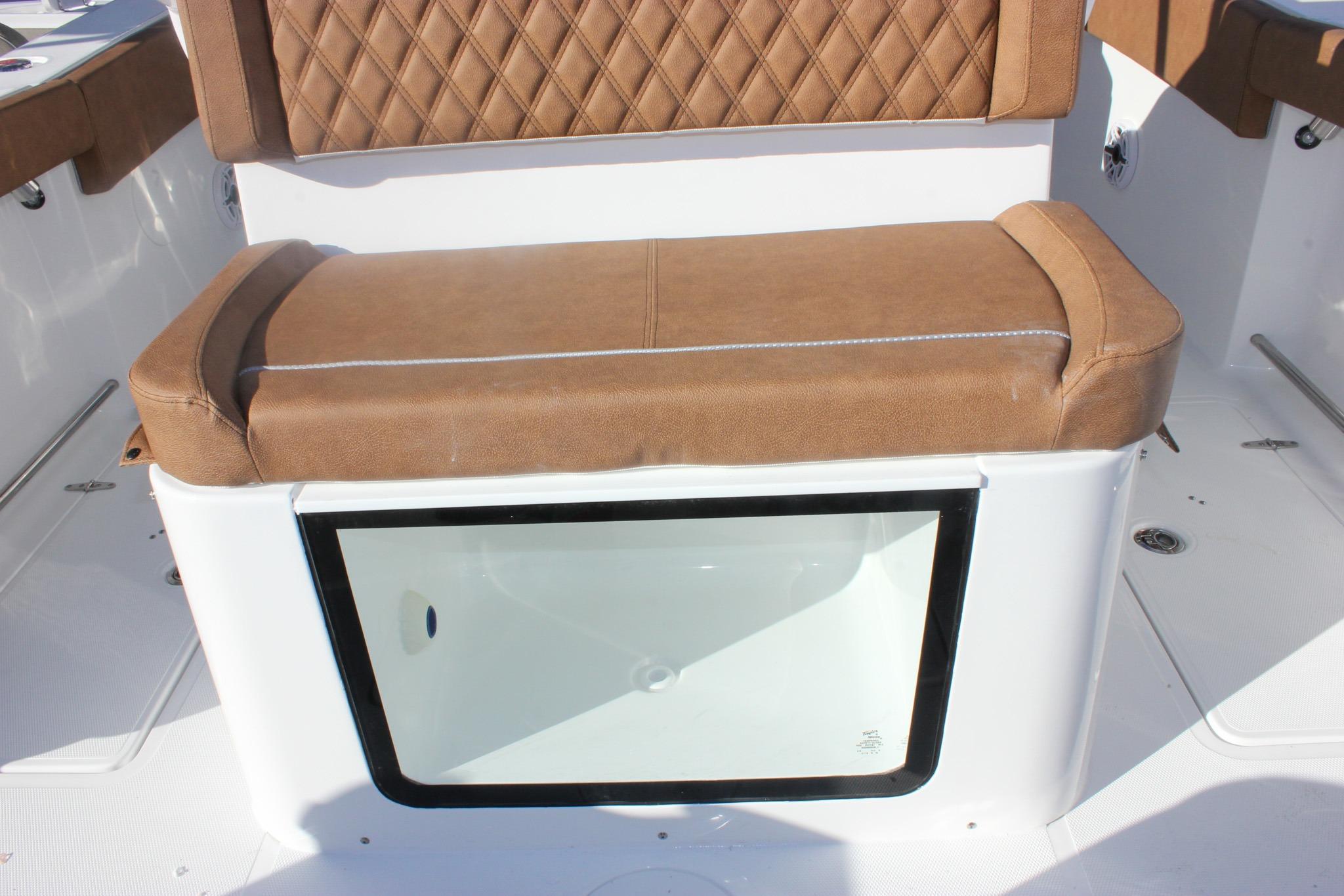 2026 Sea Hunt Ultra 285 SE boat seat with storage compartment, brown upholstery.