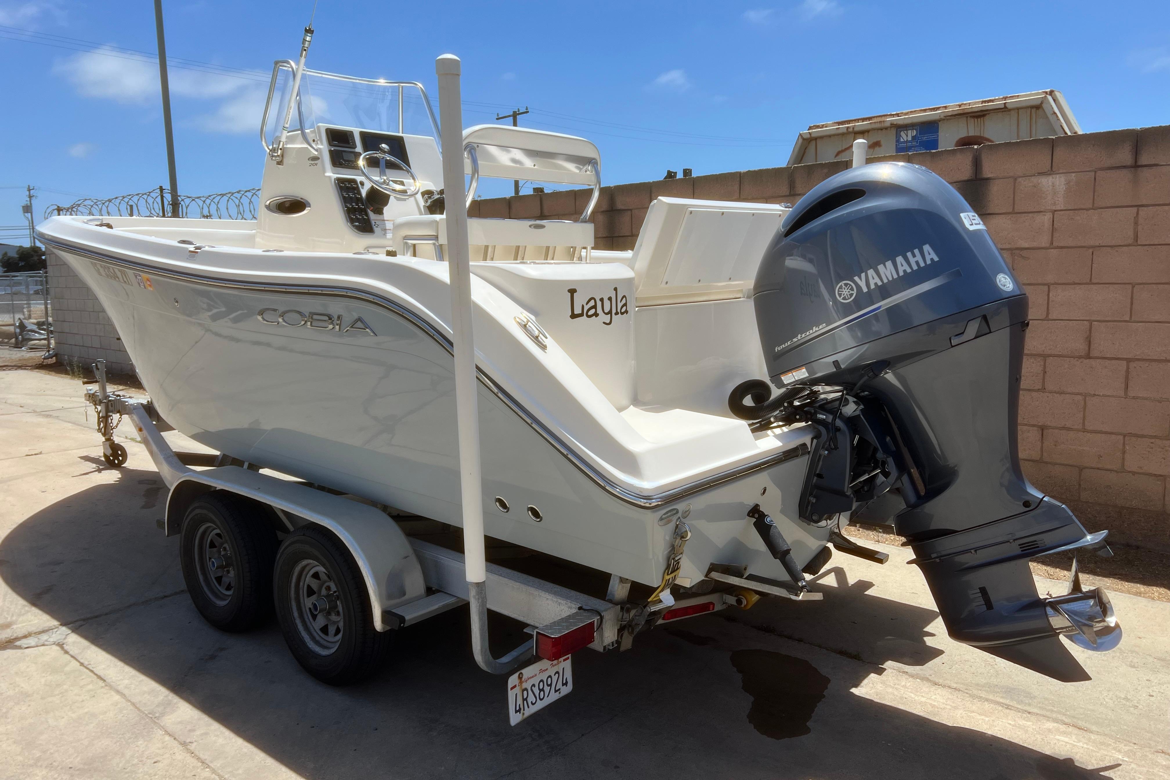 2018 Cobia 201 Center Console boat on trailer with Yamaha outboard motor.