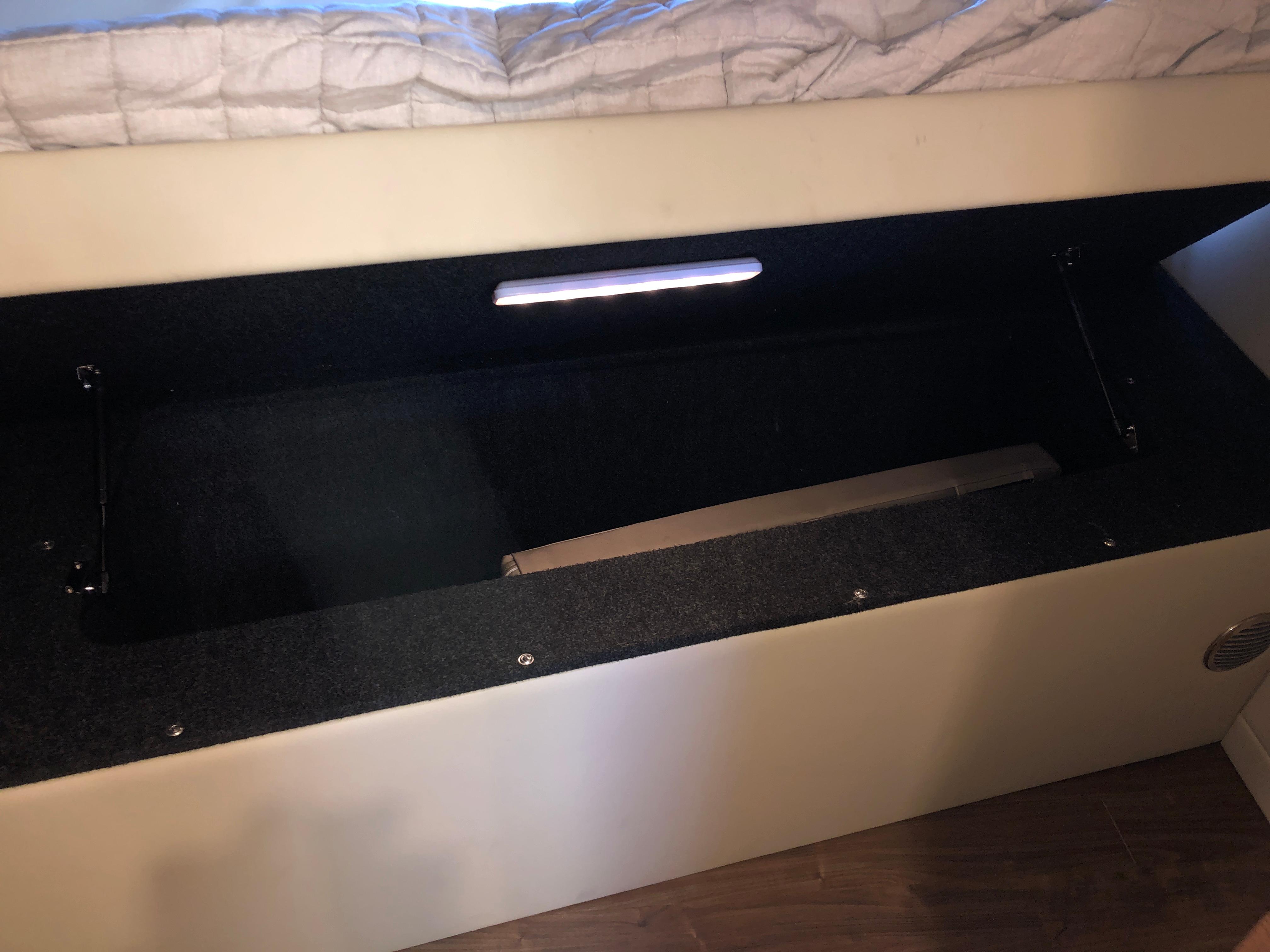 Under-bed storage compartment in a 2017 Regal 53 Sport Coupe yacht.