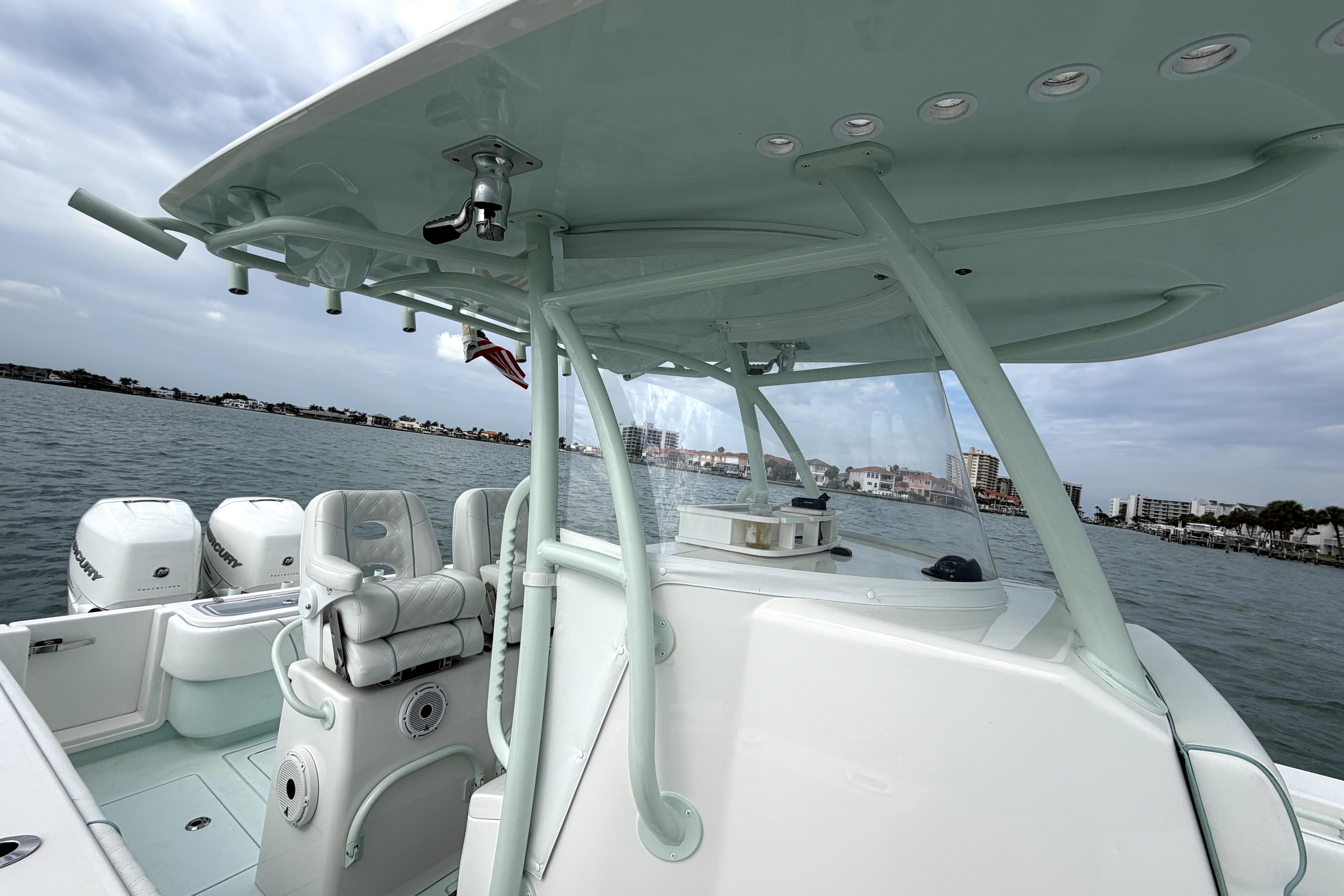2019 Contender 30 ST boat on water, featuring dual Mercury engines and spacious seating.