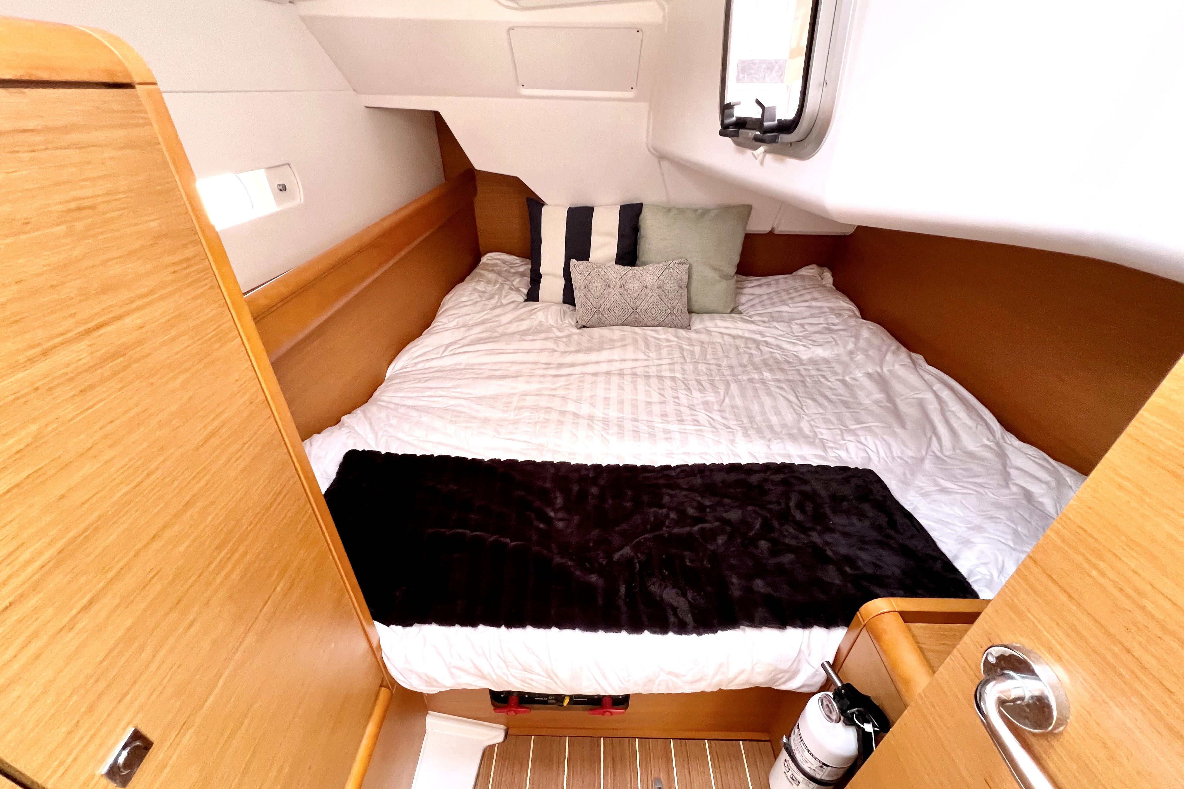 Cozy cabin interior of 2014 Jeanneau Sun Odyssey 379 sailboat with comfortable bedding.