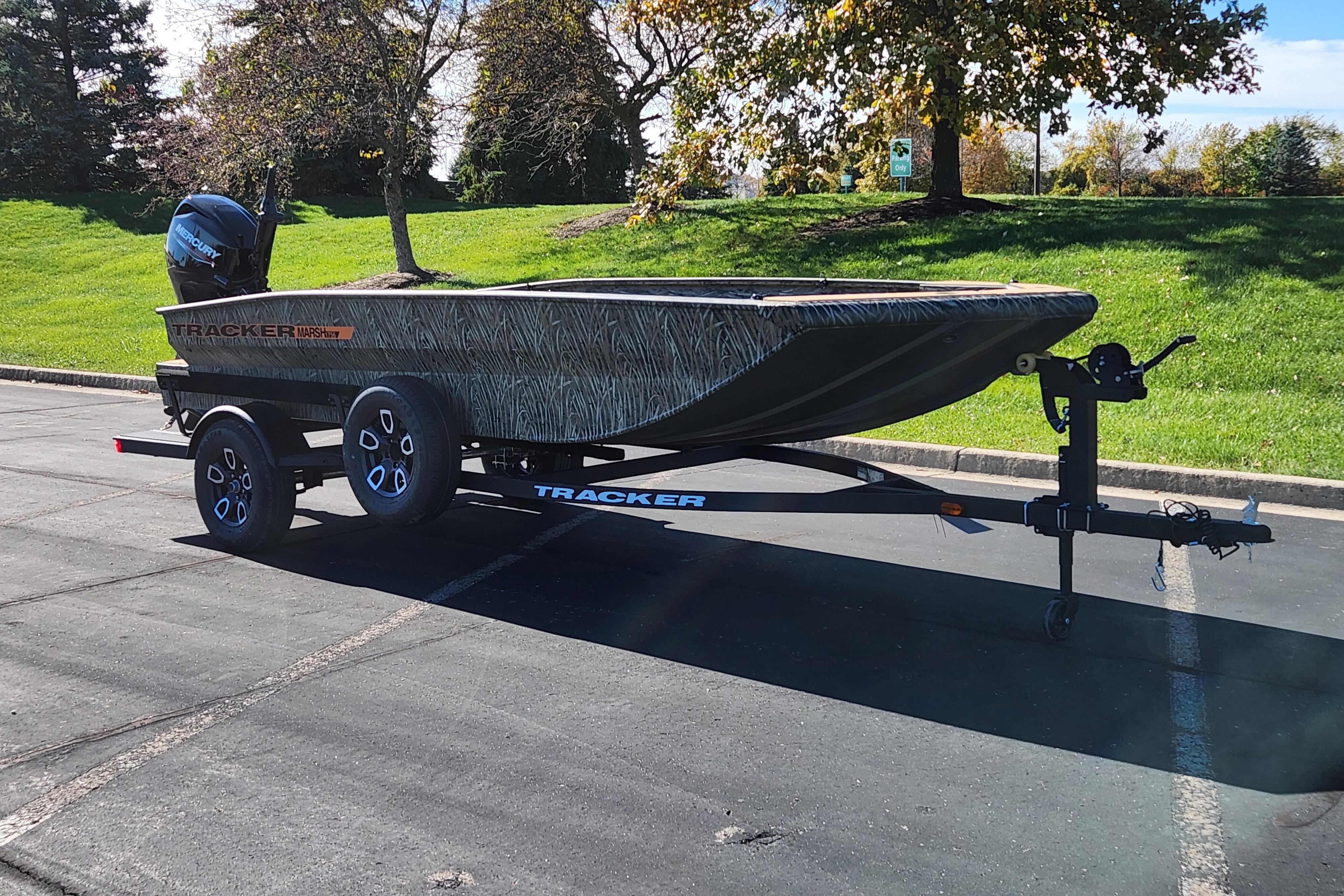 2026 Tracker Grizzly 1756 T Marsh boat on trailer in sunny parking lot.