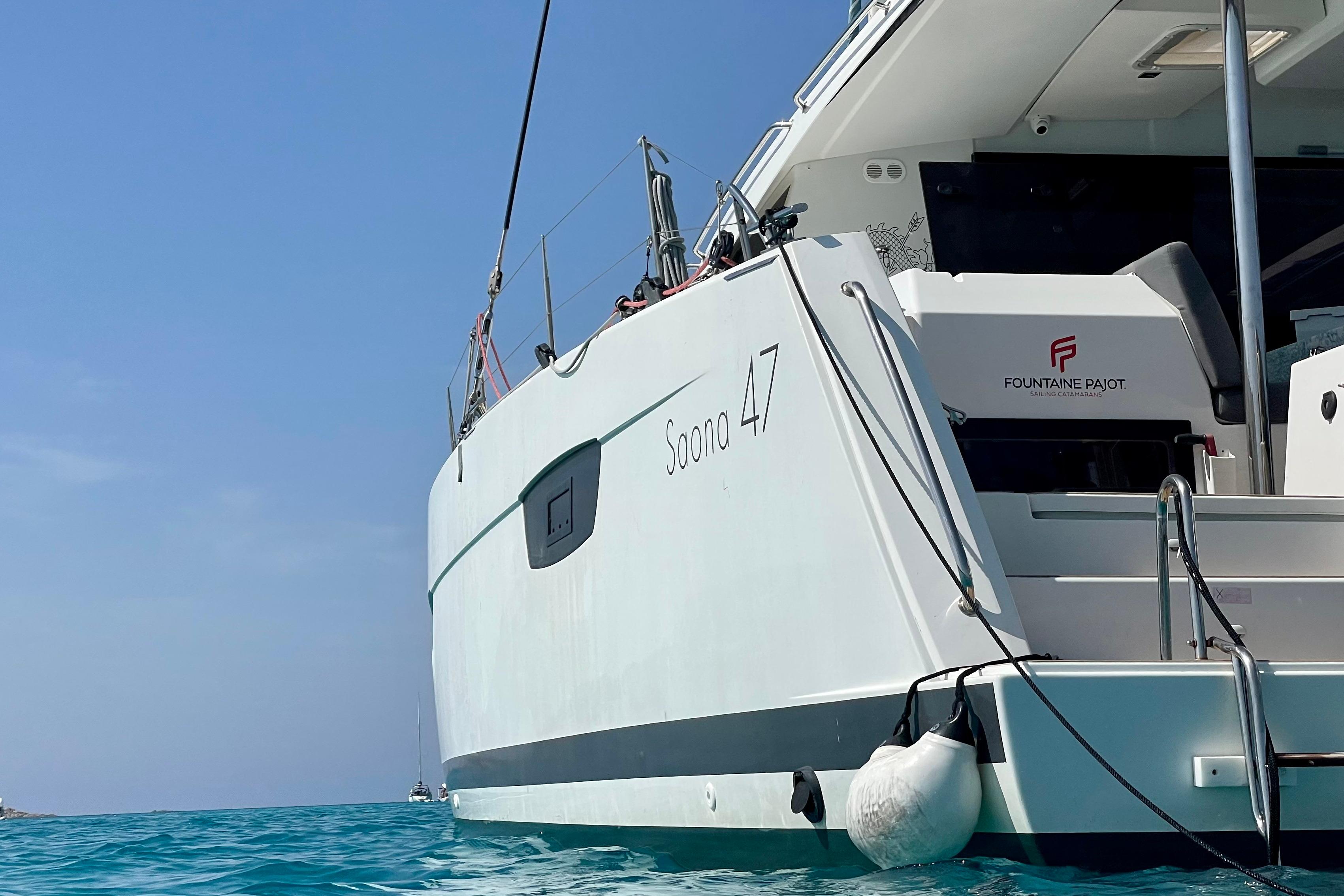 2020 Fountaine Pajot Saona 47 catamaran on clear blue water, showcasing sleek design.