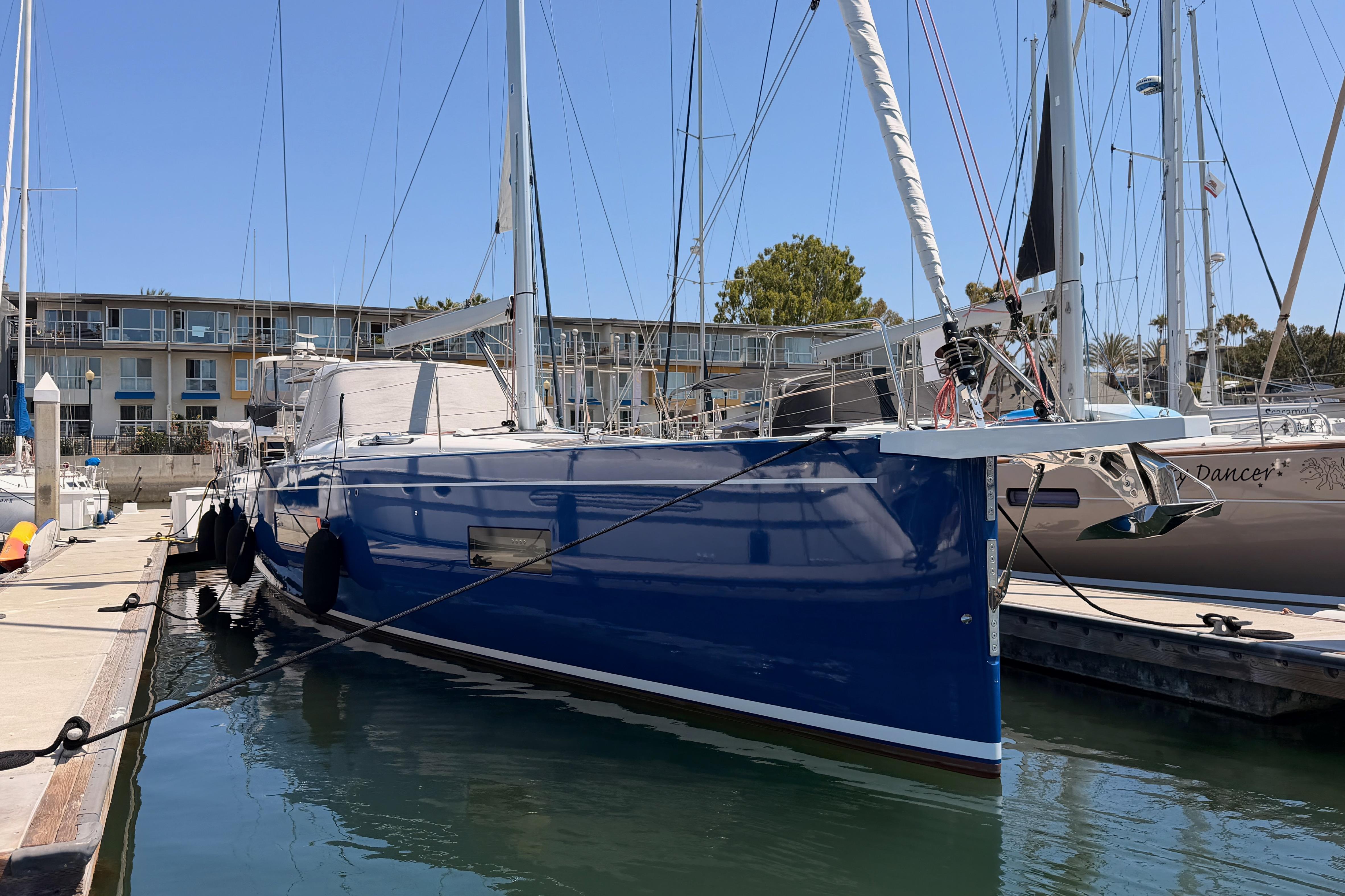 2022 Beneteau Oceanis Yacht 54 docked at marina, blue hull, sunny day.