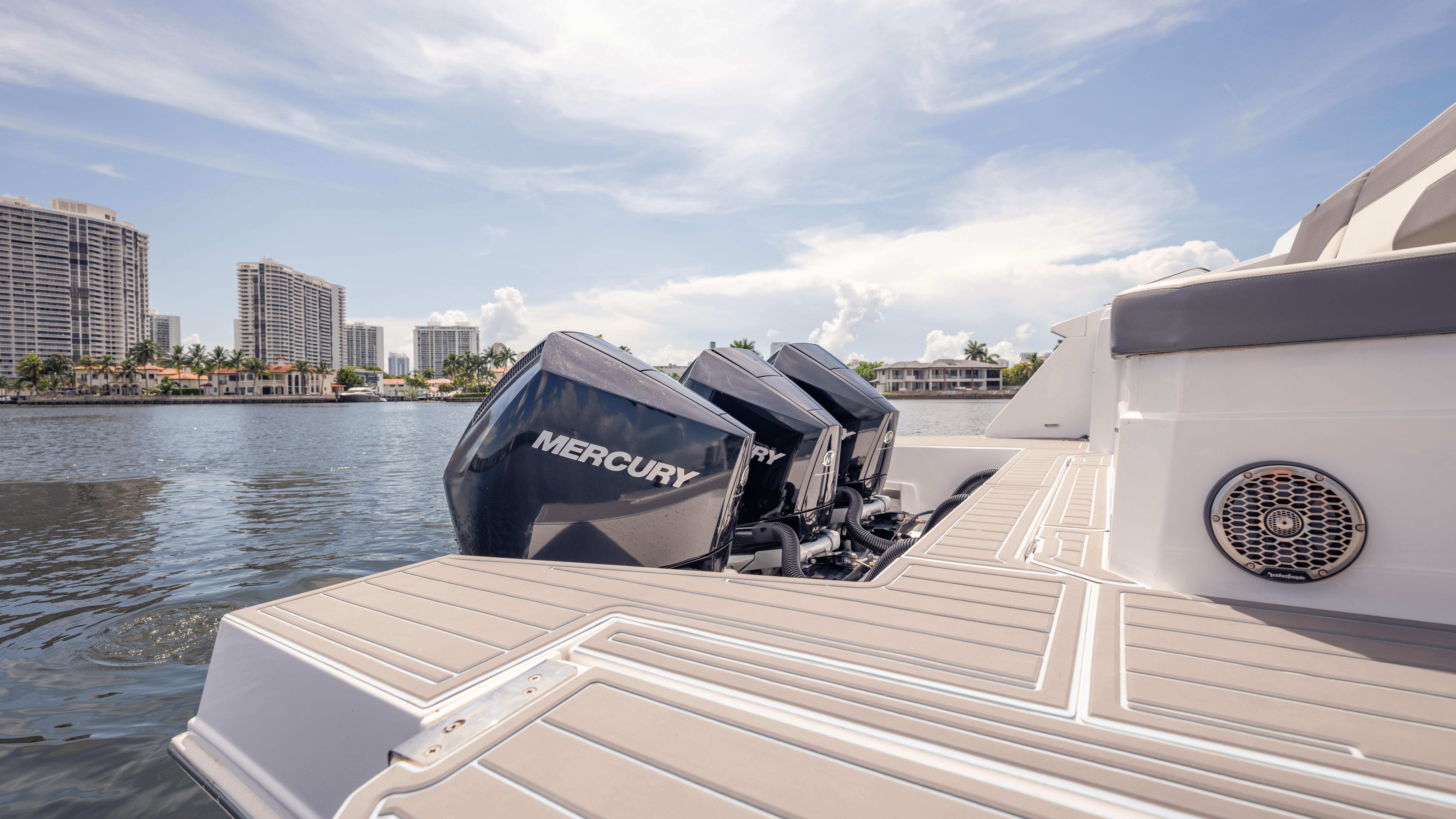 2021 Cruisers Yachts 38 GLS with Mercury engines on a sunny waterfront.