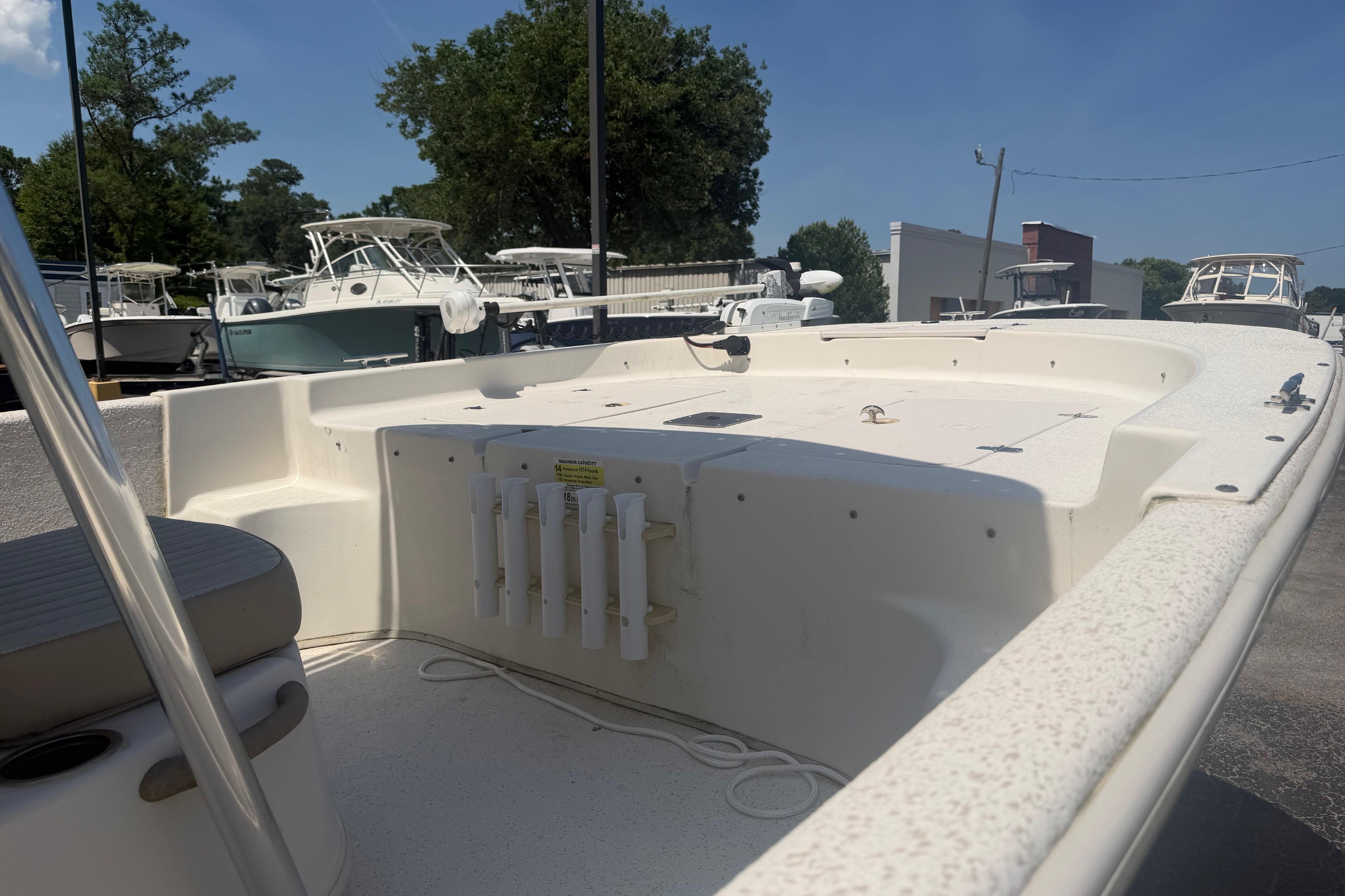2019 Carolina Skiff 218 DLV boat with spacious deck, docked outdoors.