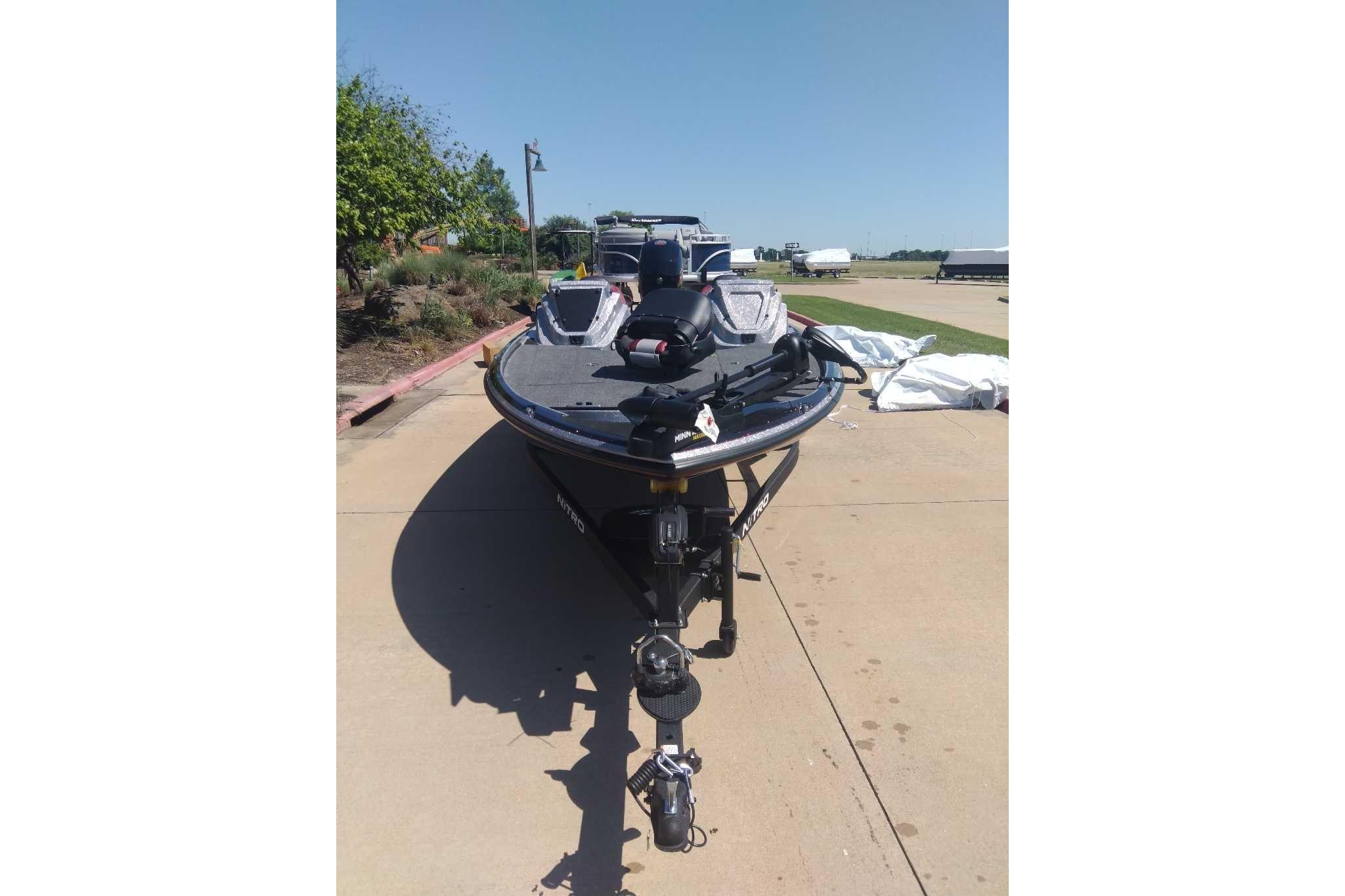 2026 Nitro Z18 boat on trailer, parked outdoors on sunny day.