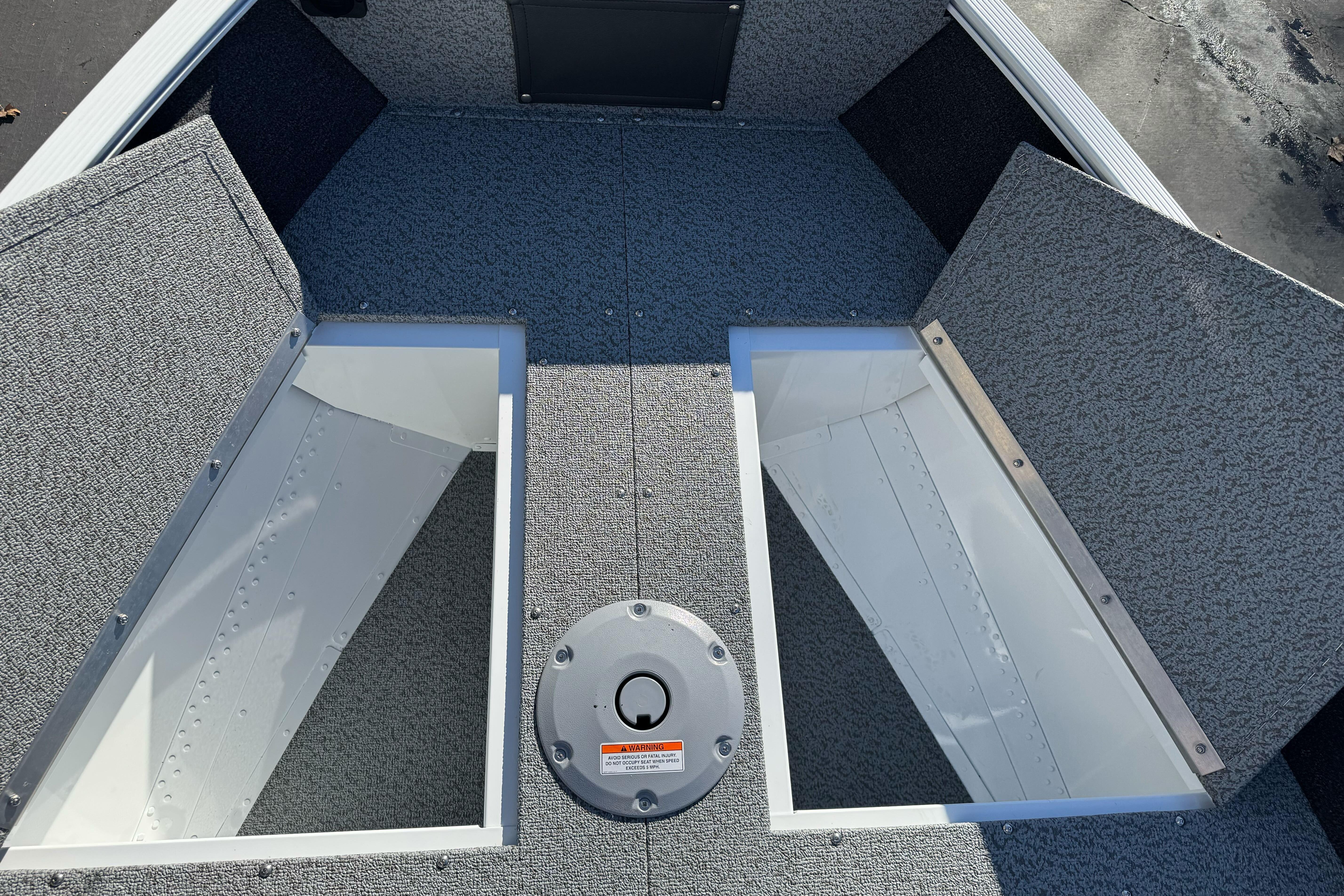 2026 Lund 1650 Angler SS boat interior with open storage compartments.