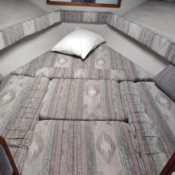 Interior cabin of 1988 Sea Ray 268 DA with patterned cushions and a pillow.